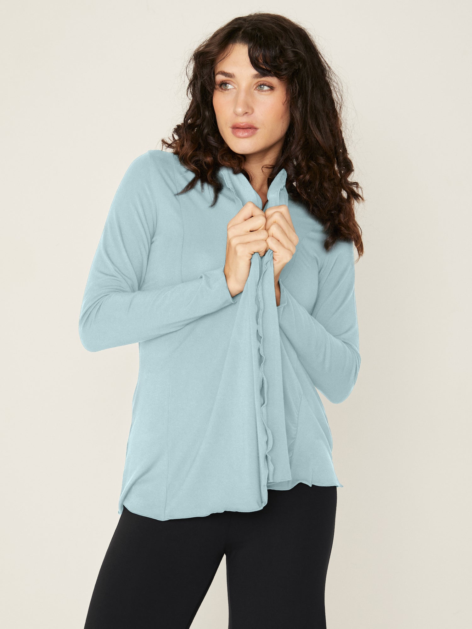 Woman wearing a bamboo light topaz blue cardigan with black wide leg palazzo pants