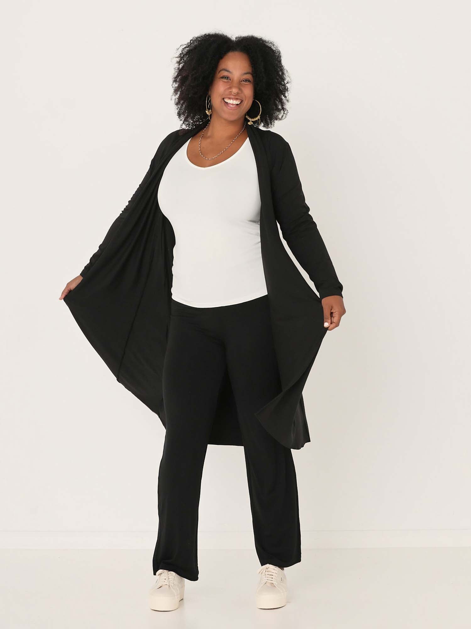 Model wearing black long cardigan, below knee length jacket with long fitted sleeves, women's bamboo clothing