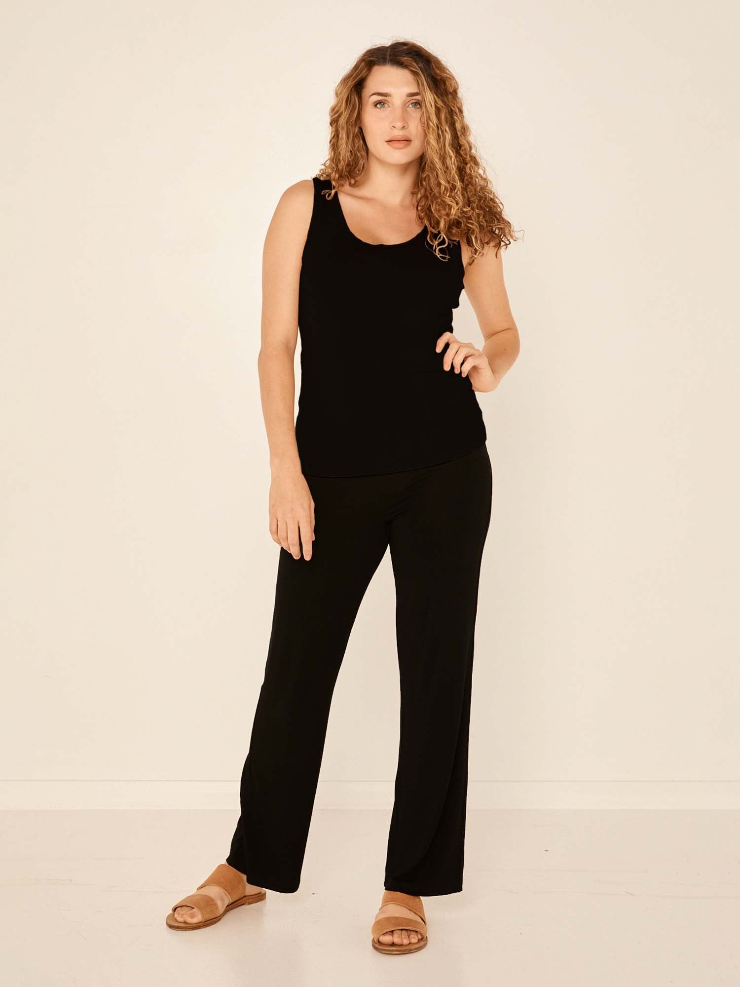 Model wearing black full length straight leg pants, double layered adjustible/high waistband, classic cut, women's bamboo clothing
