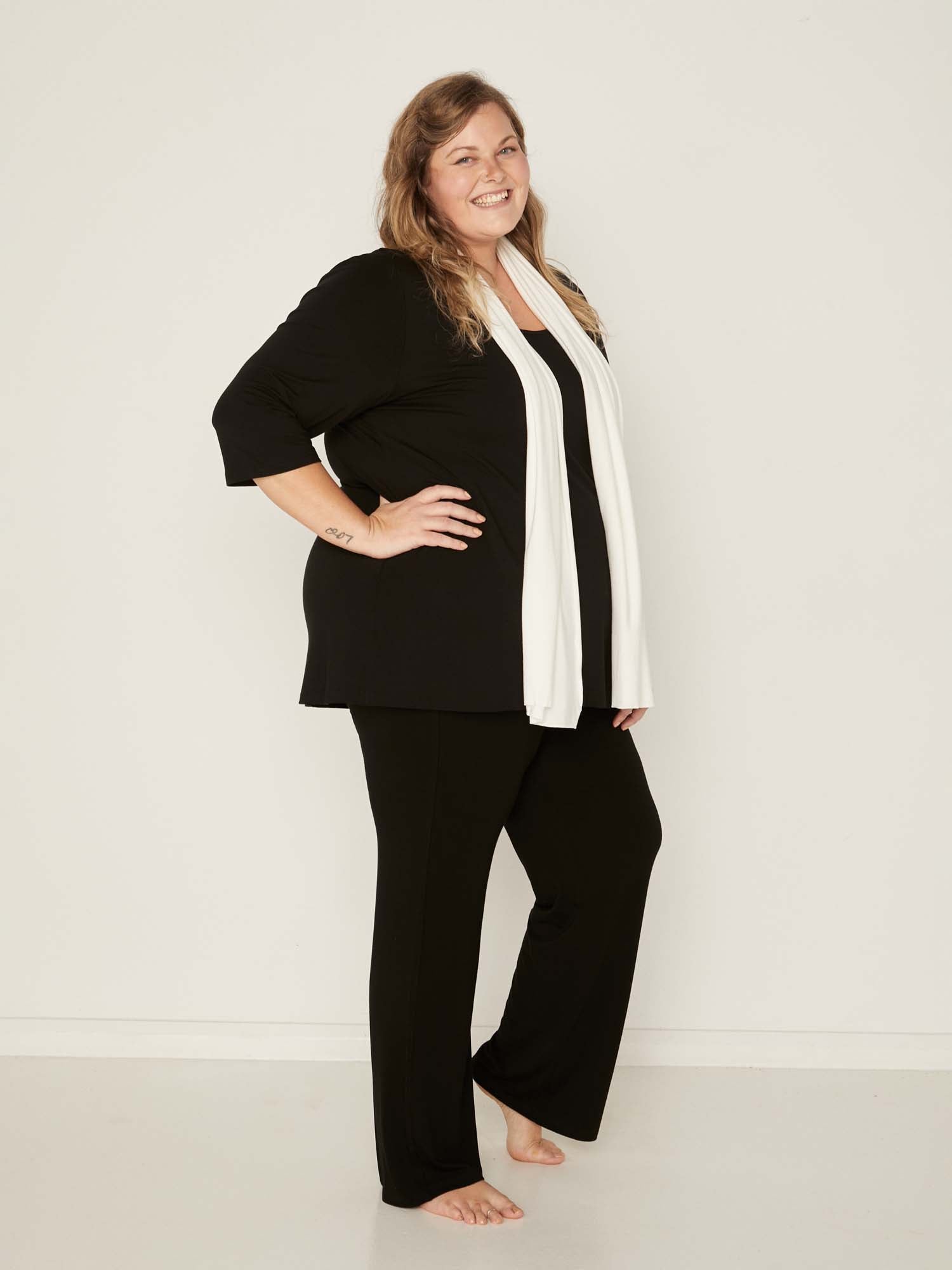 Model wearing black full length straight leg pants, double layered adjustible/high waistband, classic cut, women's bamboo clothing