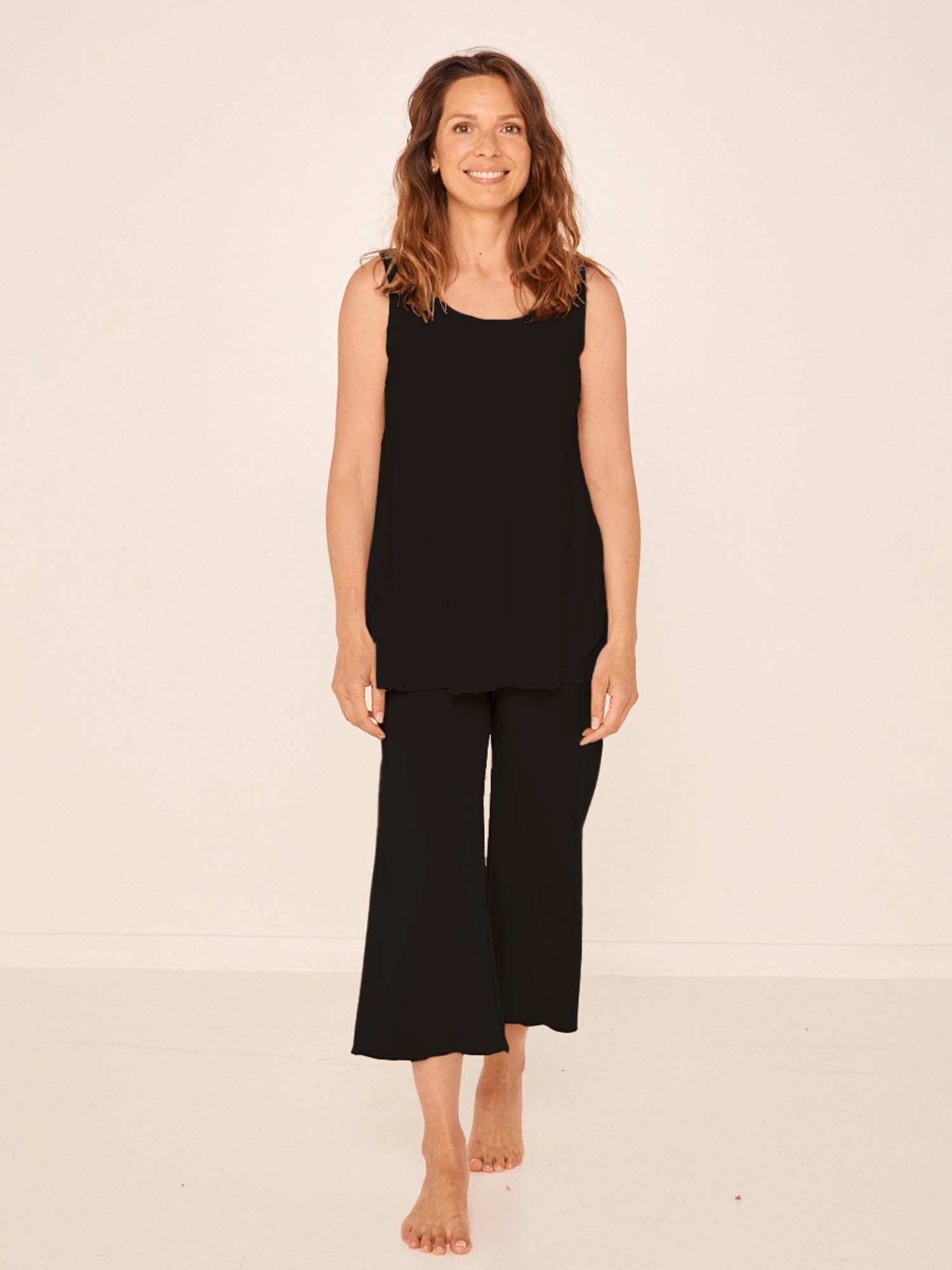 Model wearing black 7/8 length resort pants, double layered adjustible high waistband, classic design, women's bamboo clothing