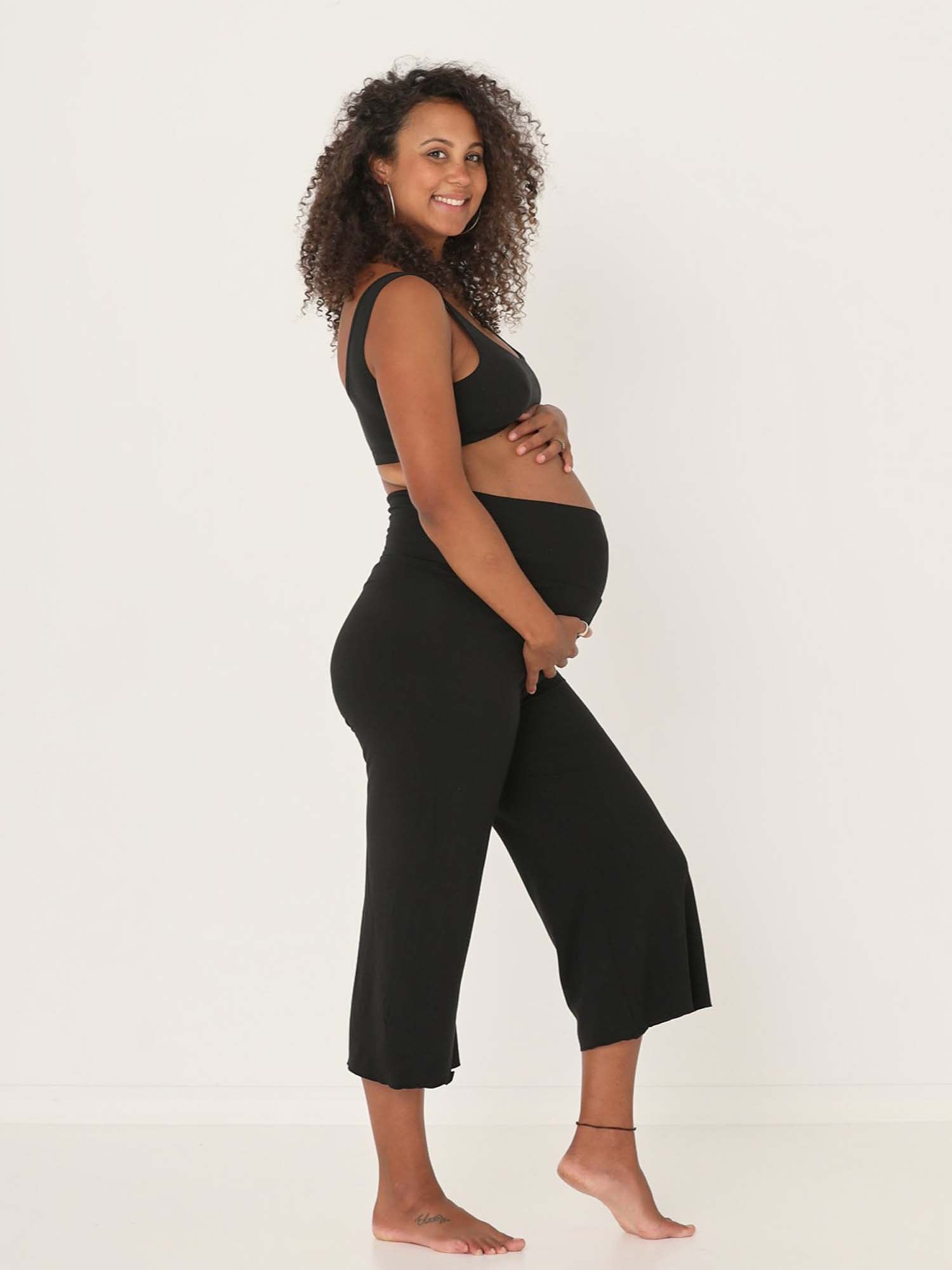 Model wearing black 7/8 length resort pants, double layered adjustible high waistband, classic design, women's bamboo clothing