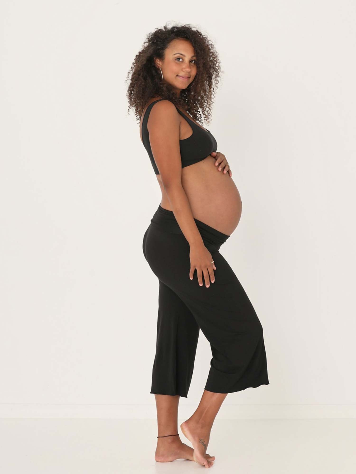 Model wearing black 7/8 length resort pants, double layered adjustible high waistband, classic design, women's bamboo clothing