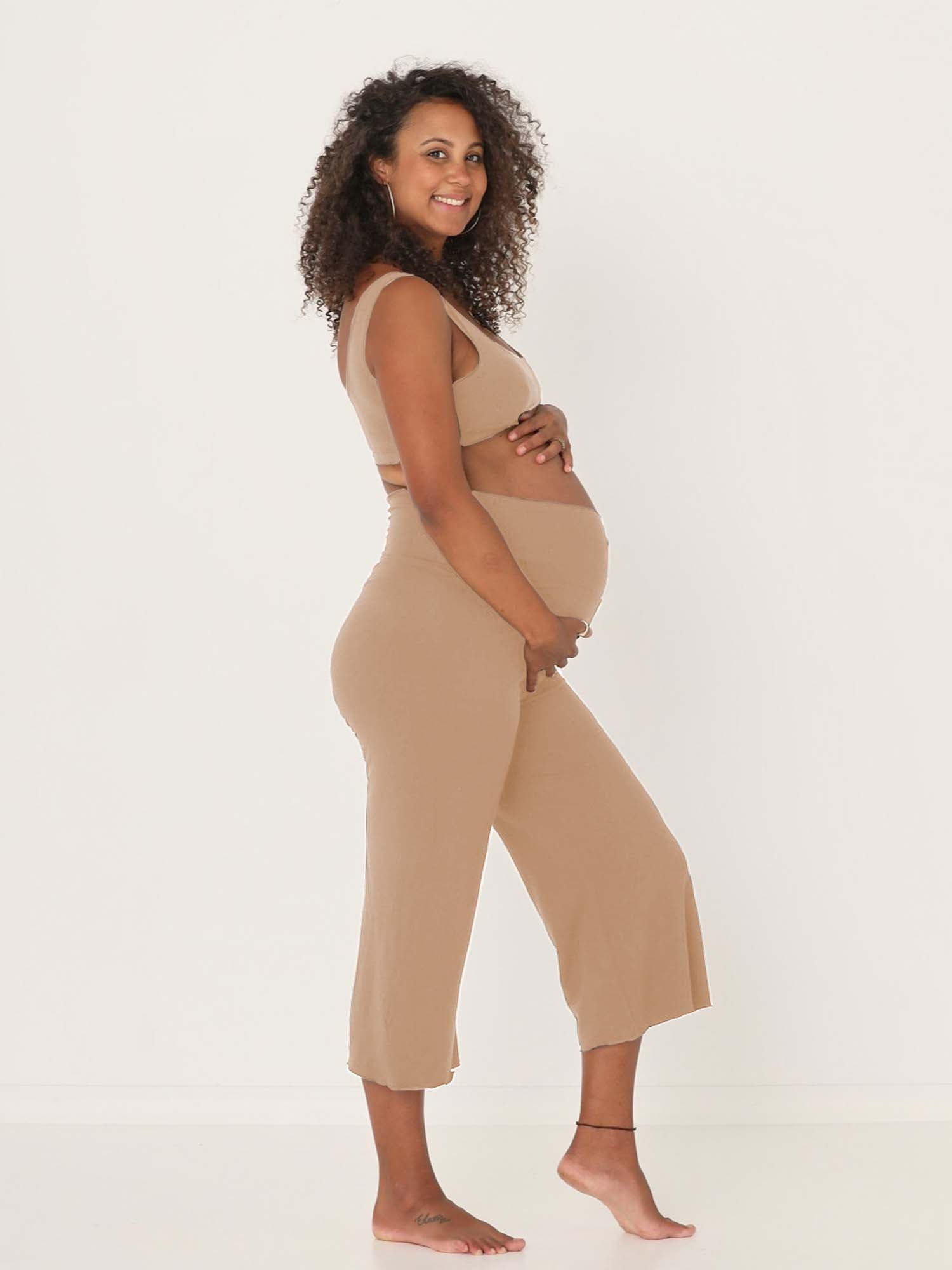 Model wearing caramel 7/8 length resort pants, double layered adjustable high waistband, classic design, women's bamboo clothing