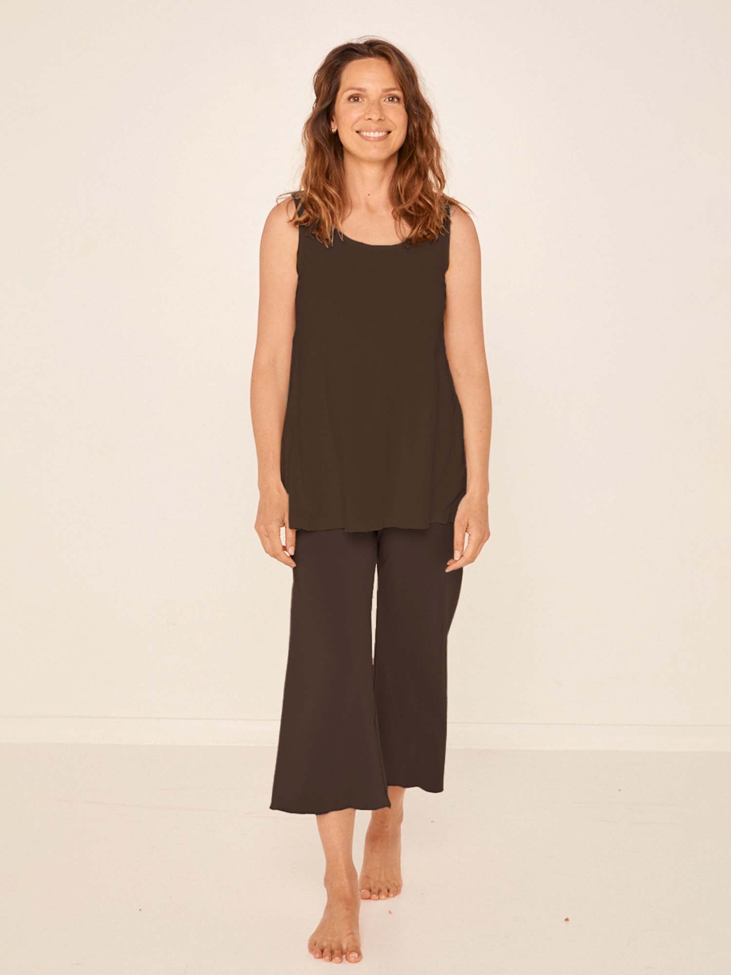 Model wearing cocoa brown 7/8 length resort pants, double layered adjustible high waistband, classic design, women's bamboo clothing