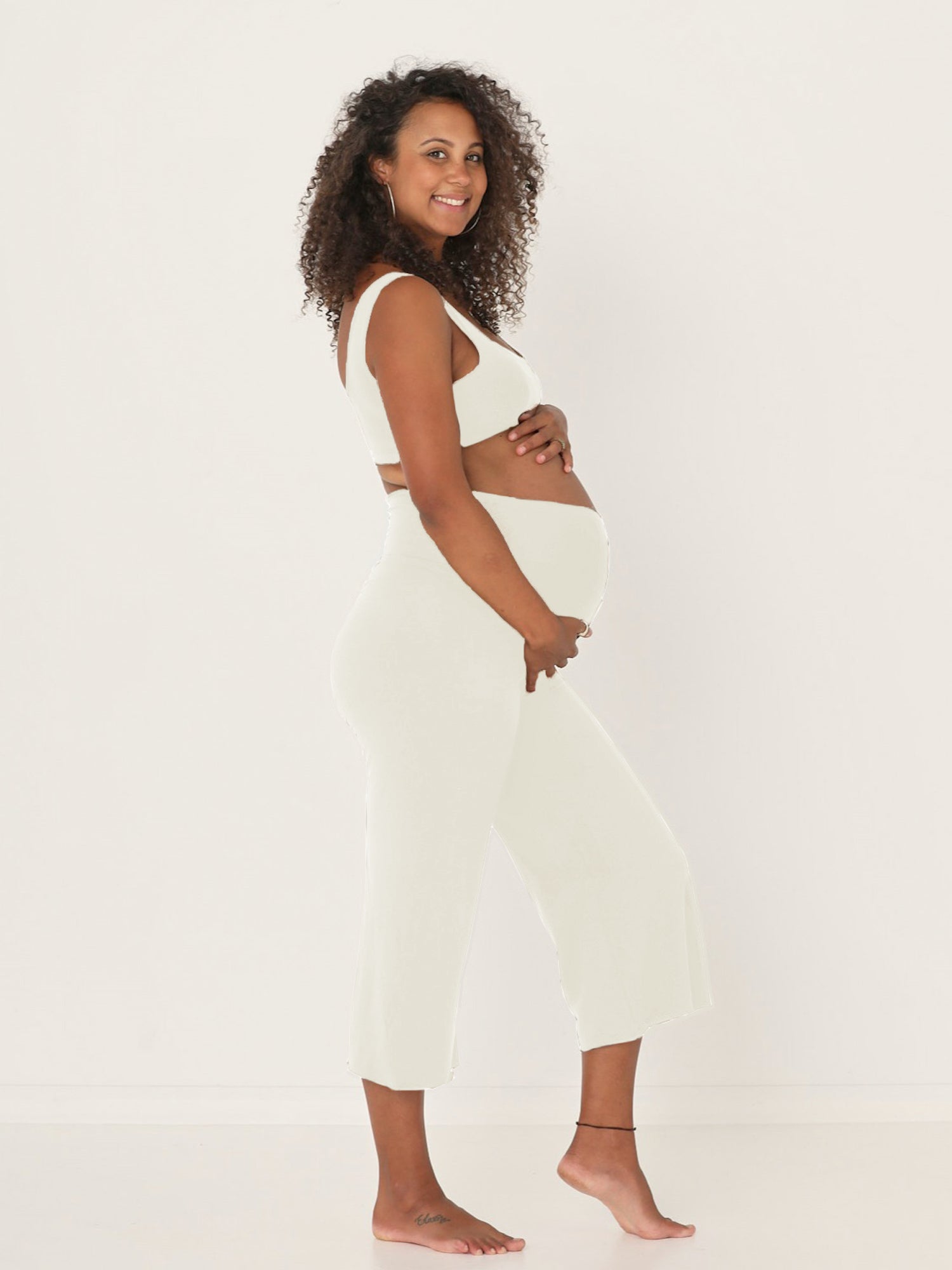 Model wearing cream 7/8 length resort pants, double layered adjustible high waistband, classic design, women's bamboo clothing
