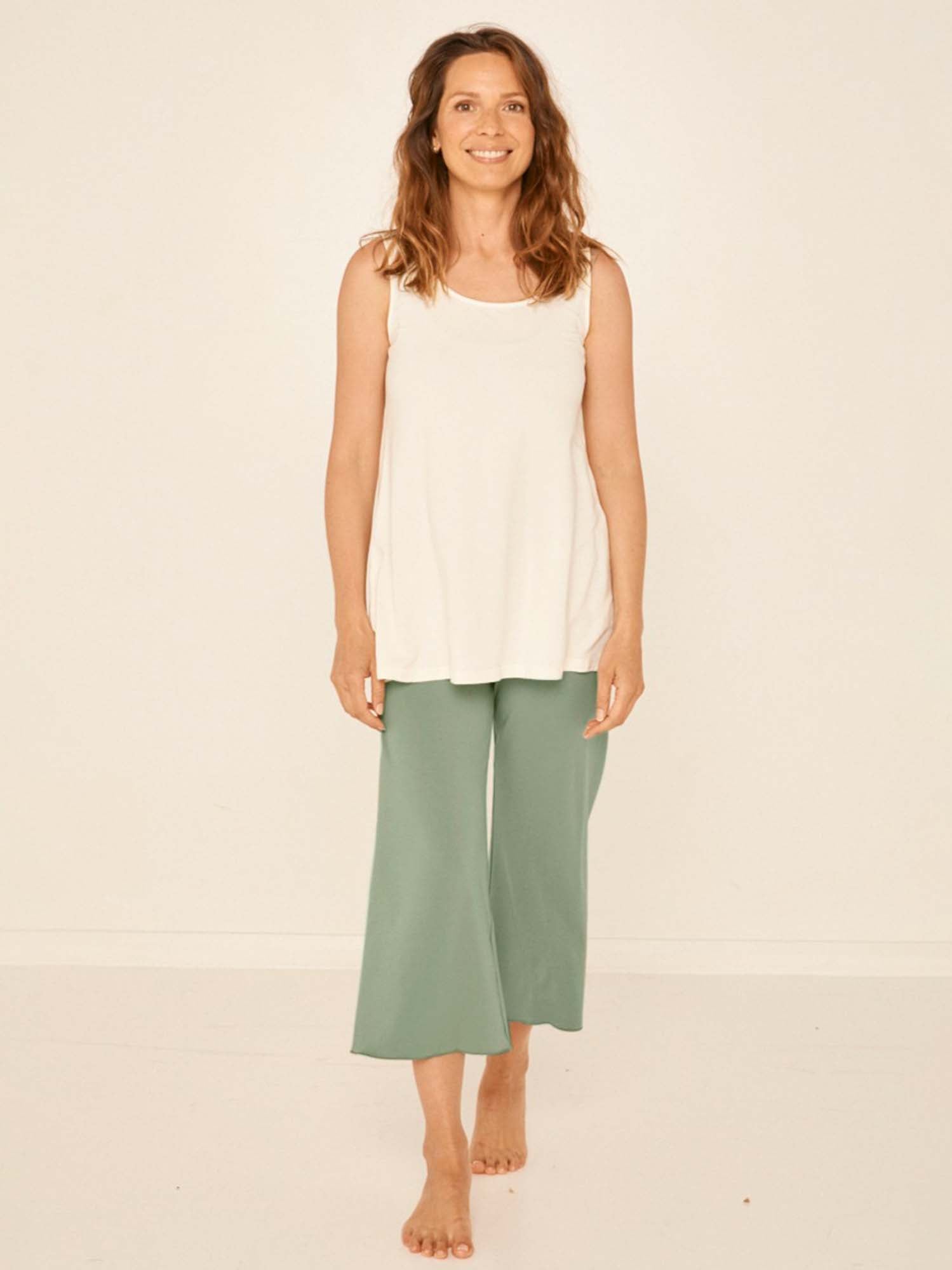 Model wearing eucalyptus green 7/8 length resort pants, double layered adjustible high waistband, classic design, women's bamboo clothing