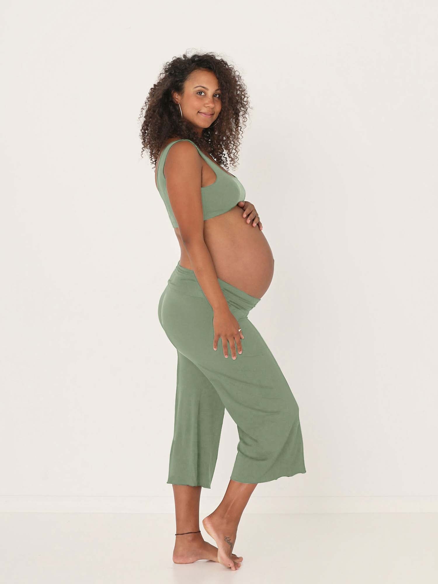Model wearing eucalyptus green 7/8 length resort pants, double layered adjustible high waistband, classic design, women's bamboo clothing