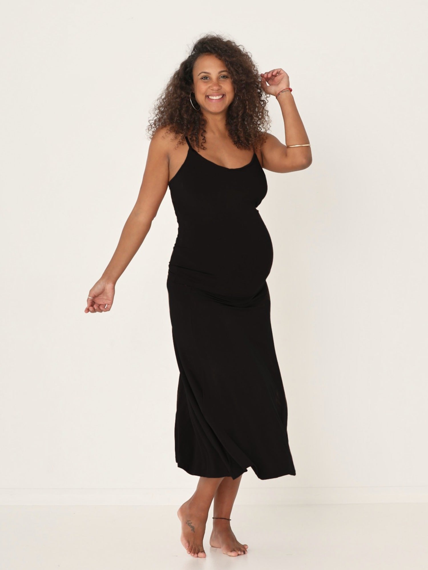 Model wearing black swing style long swishy skirt, mid - low calf length, double layered deep waistband, women's bamboo clothing