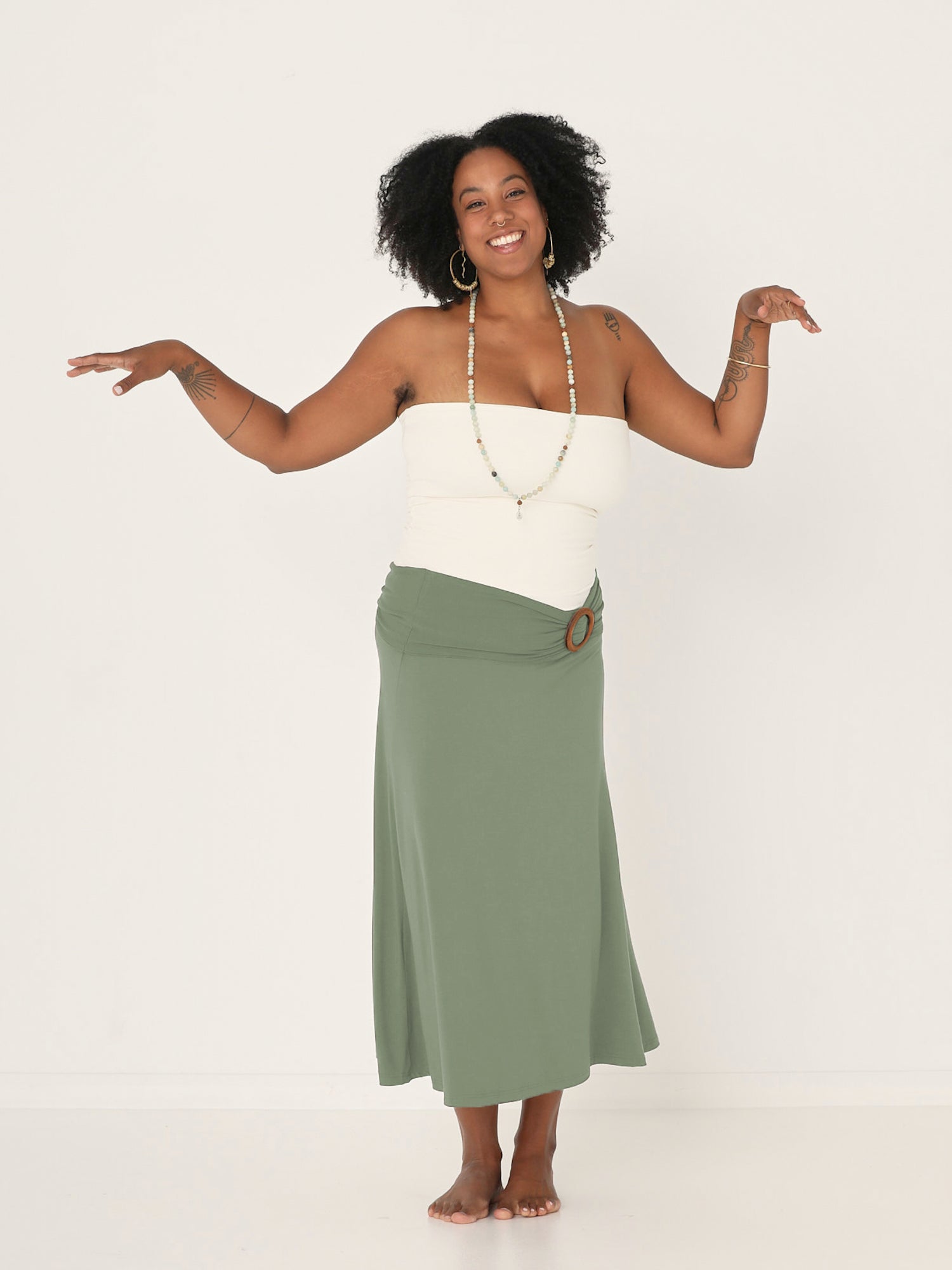 Model wearing eucalyptus swing style long swishy skirt, mid - low calf length, double layered deep waistband, women's bamboo clothing