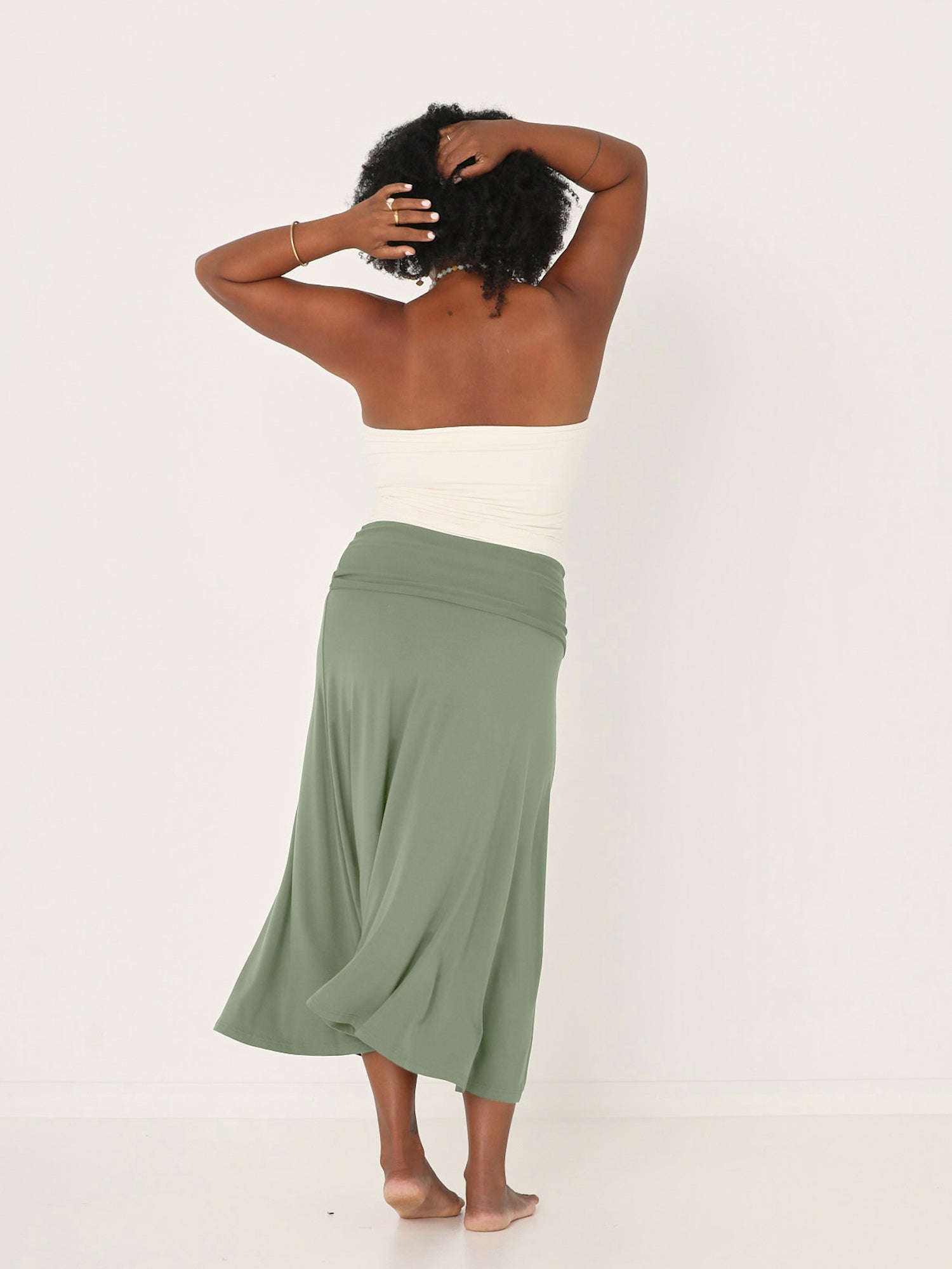Model wearing eucalyptus swing style long swishy skirt, mid - low calf length, double layered deep waistband, women's bamboo clothing