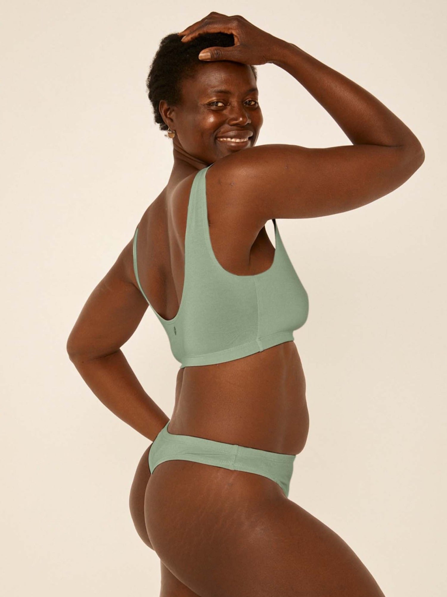 model wearing eucalyptus green hip g-string, mid waist, thong back, fuller coverage g-string, women's bamboo underwear