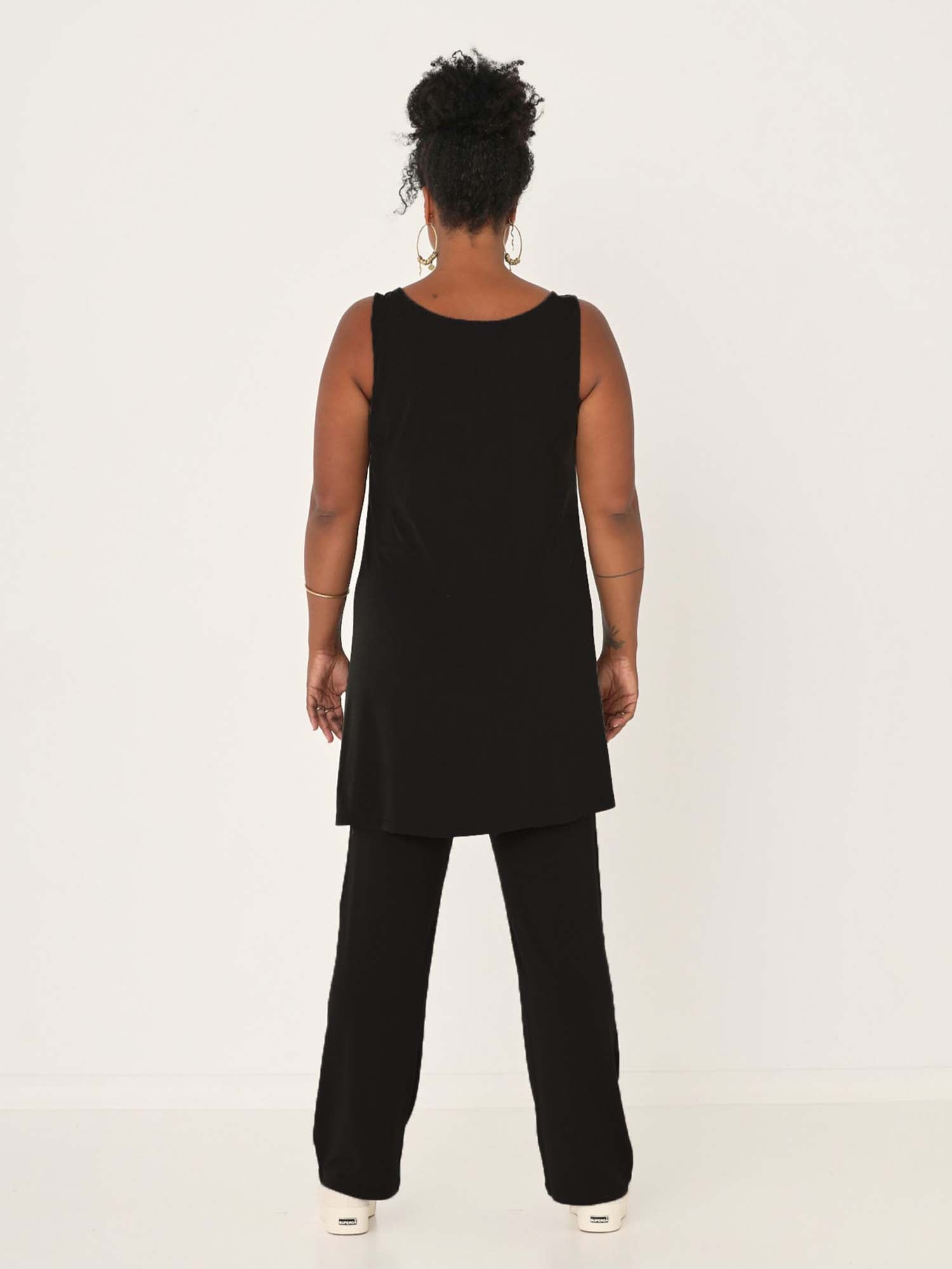 model wearing a black reversible sleeveless tunic with scoop and boat necklines, a-line singlet shape, mini length, women's bamboo clothing