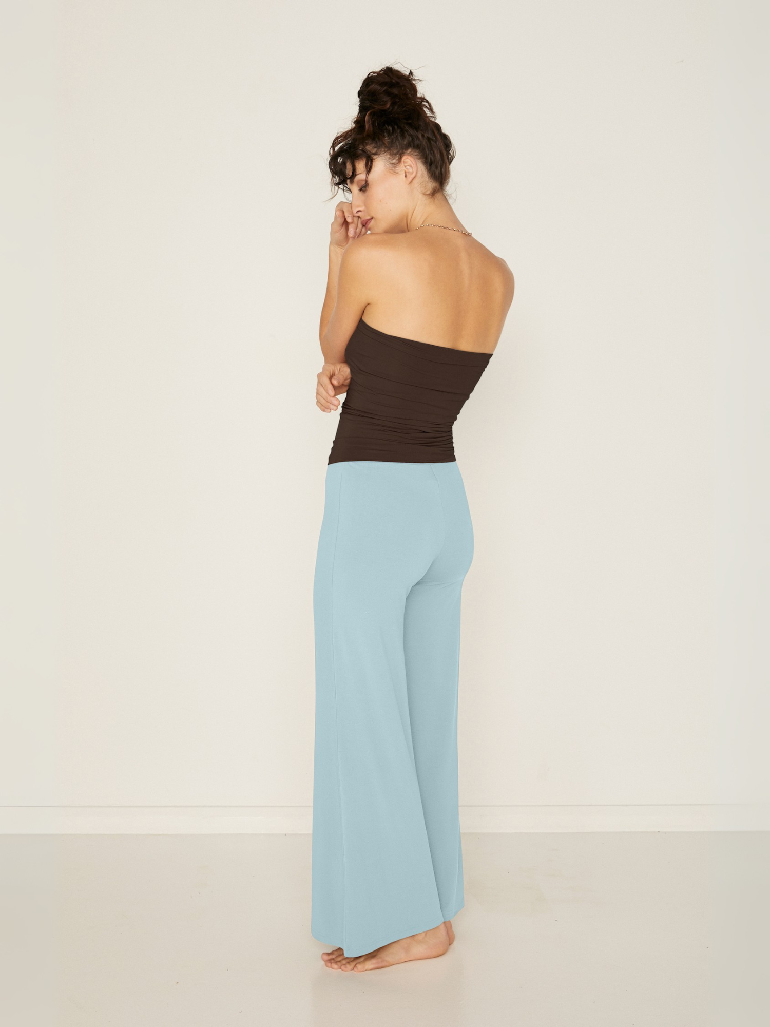 woman wearing a Bamboo light topaz blue palazzo pants with a cocoa brown tube top