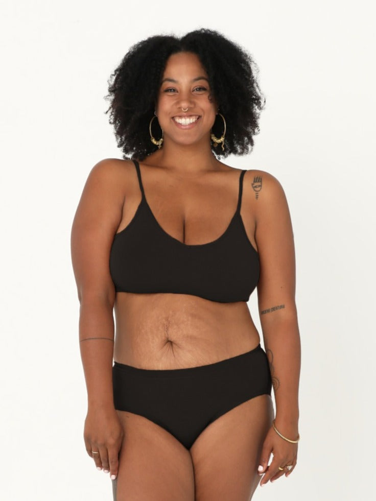 Model wearing a black wireless yoga bra, subtle v front, soft cup bralette with adjustable camisole straps, women's bamboo underwear