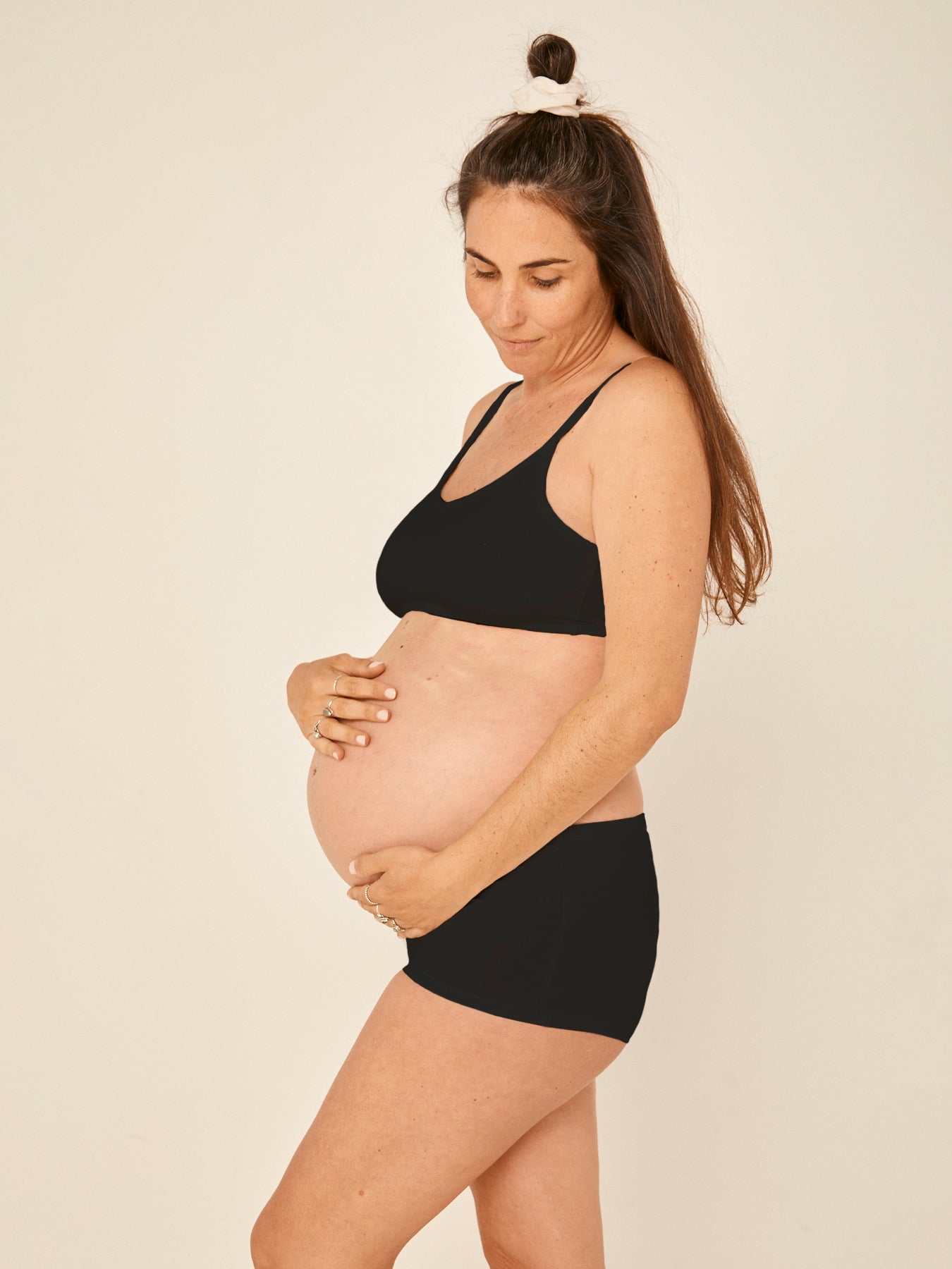 Model wearing a black wireless yoga bra, subtle v front, soft cup bralette with adjustable camisole straps, women's bamboo underwear