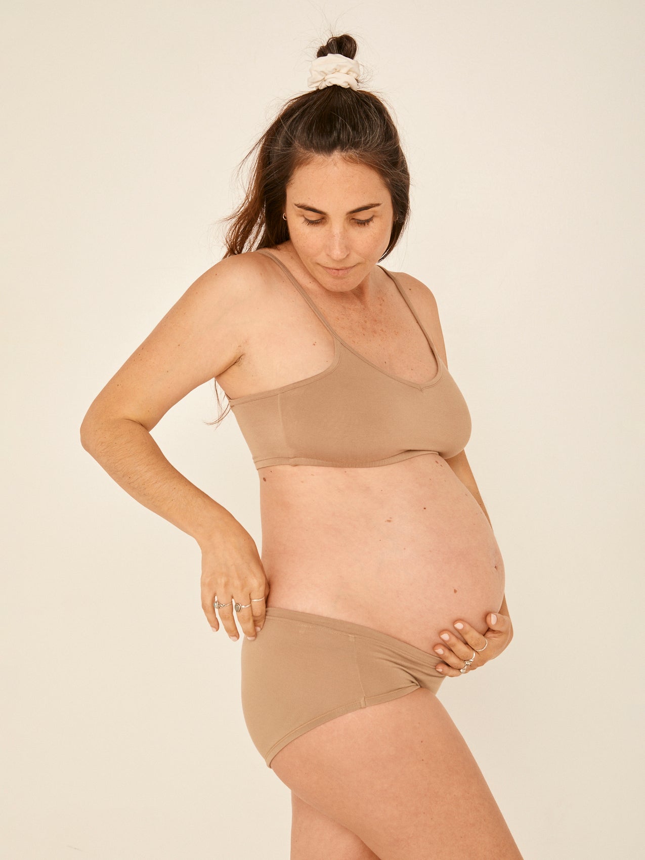 Model wearing a caramel wireless yoga bra, subtle v front, soft cup bralette with adjustable camisole straps, women's bamboo underwear