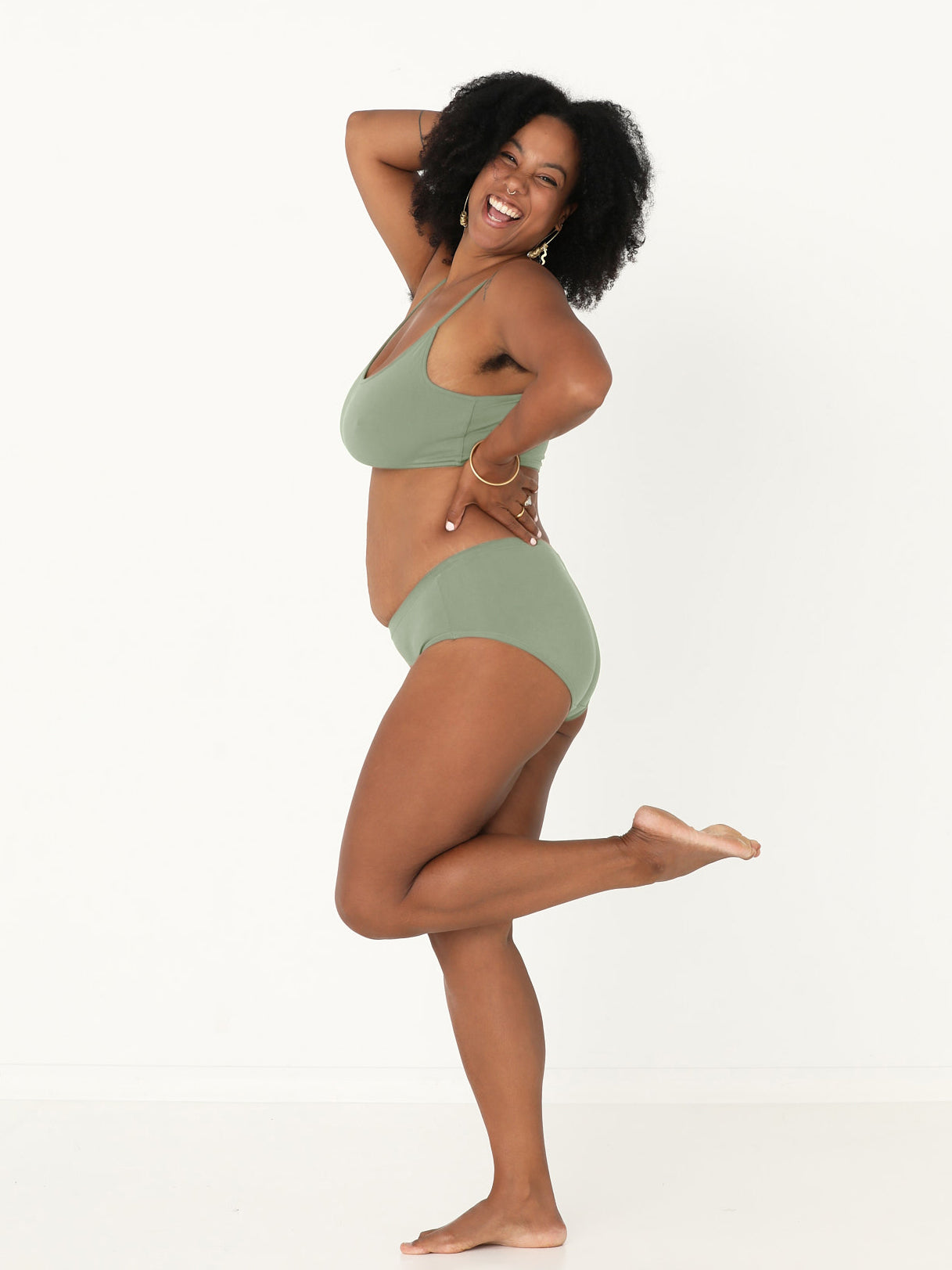 Model wearing a eucalyptus green, wireless yoga bra, subtle v front, soft cup bralette with adjustable camisole straps, women's bamboo underwear