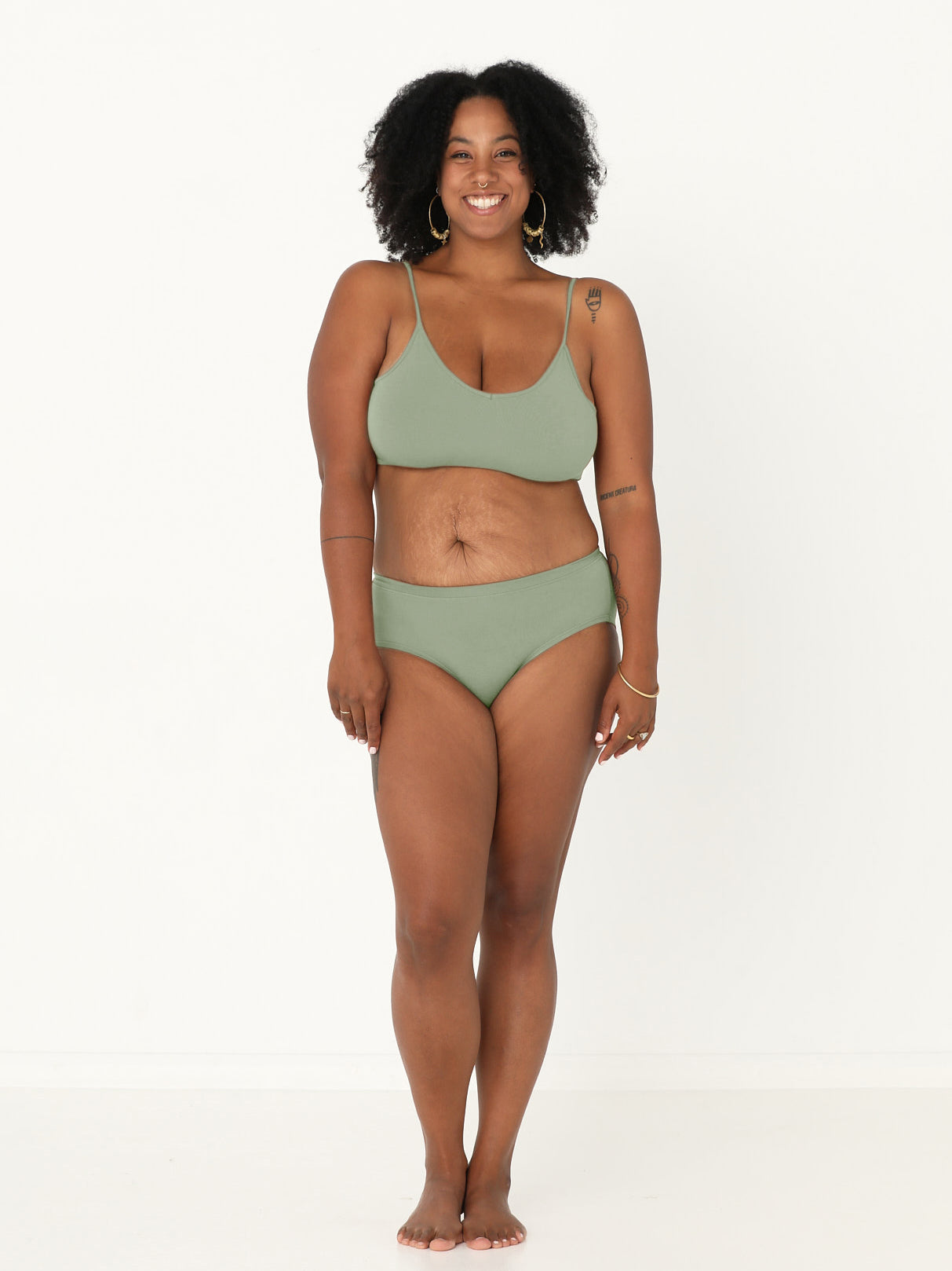 Model wearing a eucalyptus green, wireless yoga bra, subtle v front, soft cup bralette with adjustable camisole straps, women's bamboo underwear