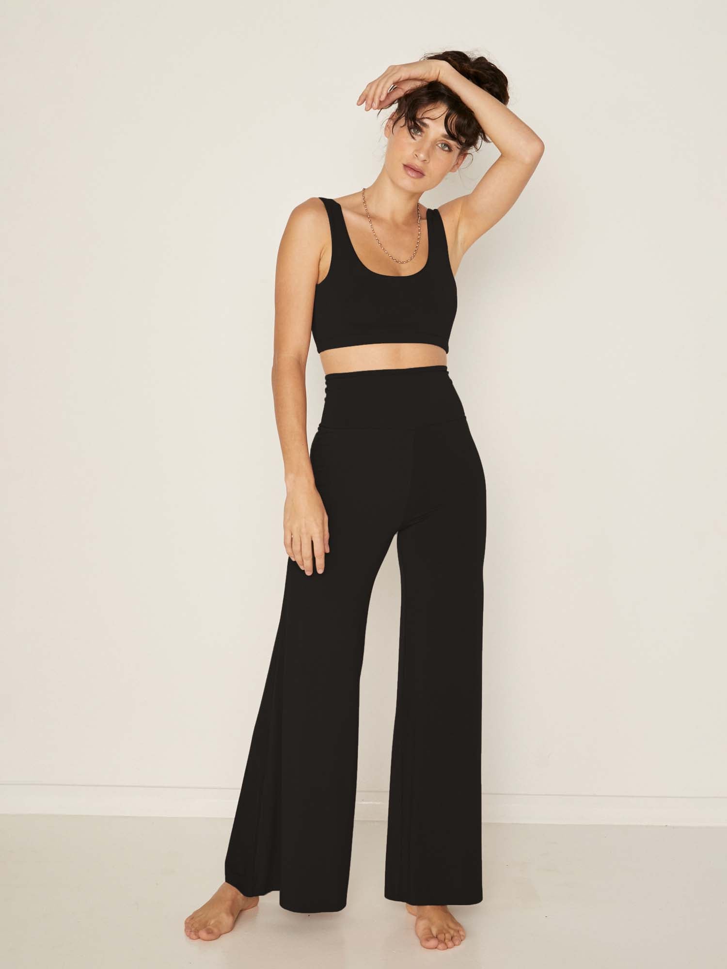 Model wearing black reversible bra, high or low scoop neckline and wide shoulder straps, wireless bra, women's bamboo underwear