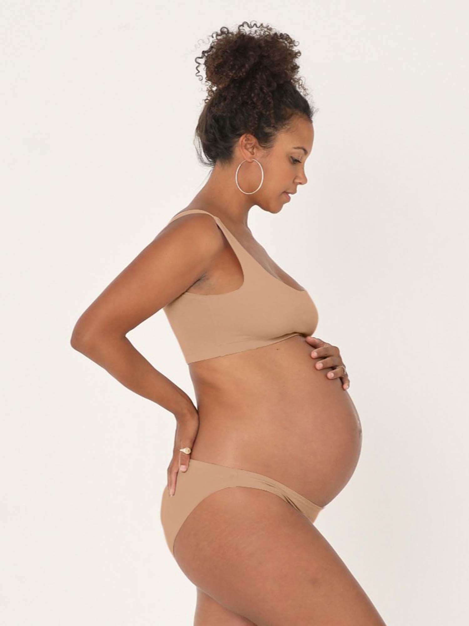 Model wearing caramel reversible bra, high or low scoop neckline and wide shoulder straps, wireless bra, women's bamboo underwear