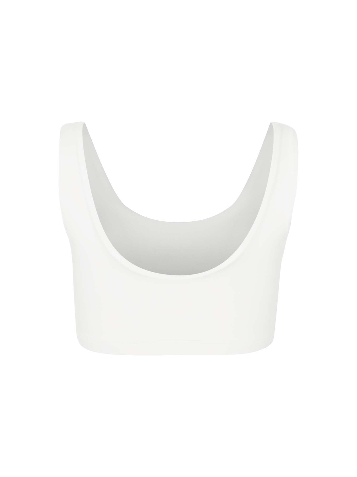 Model wearing eucalyptus cream reversible bra, high or low scoop neckline and wide shoulder straps, wireless bra, women's bamboo underwear