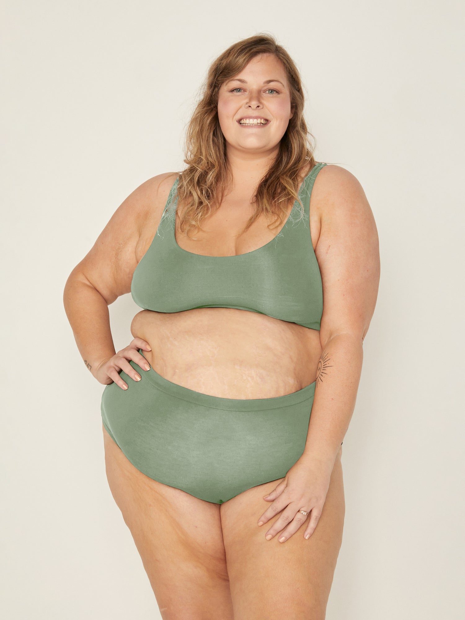 Model wearing eucalyptus green reversible bra, high or low scoop neckline and wide shoulder straps, wireless bra, women's bamboo underwear