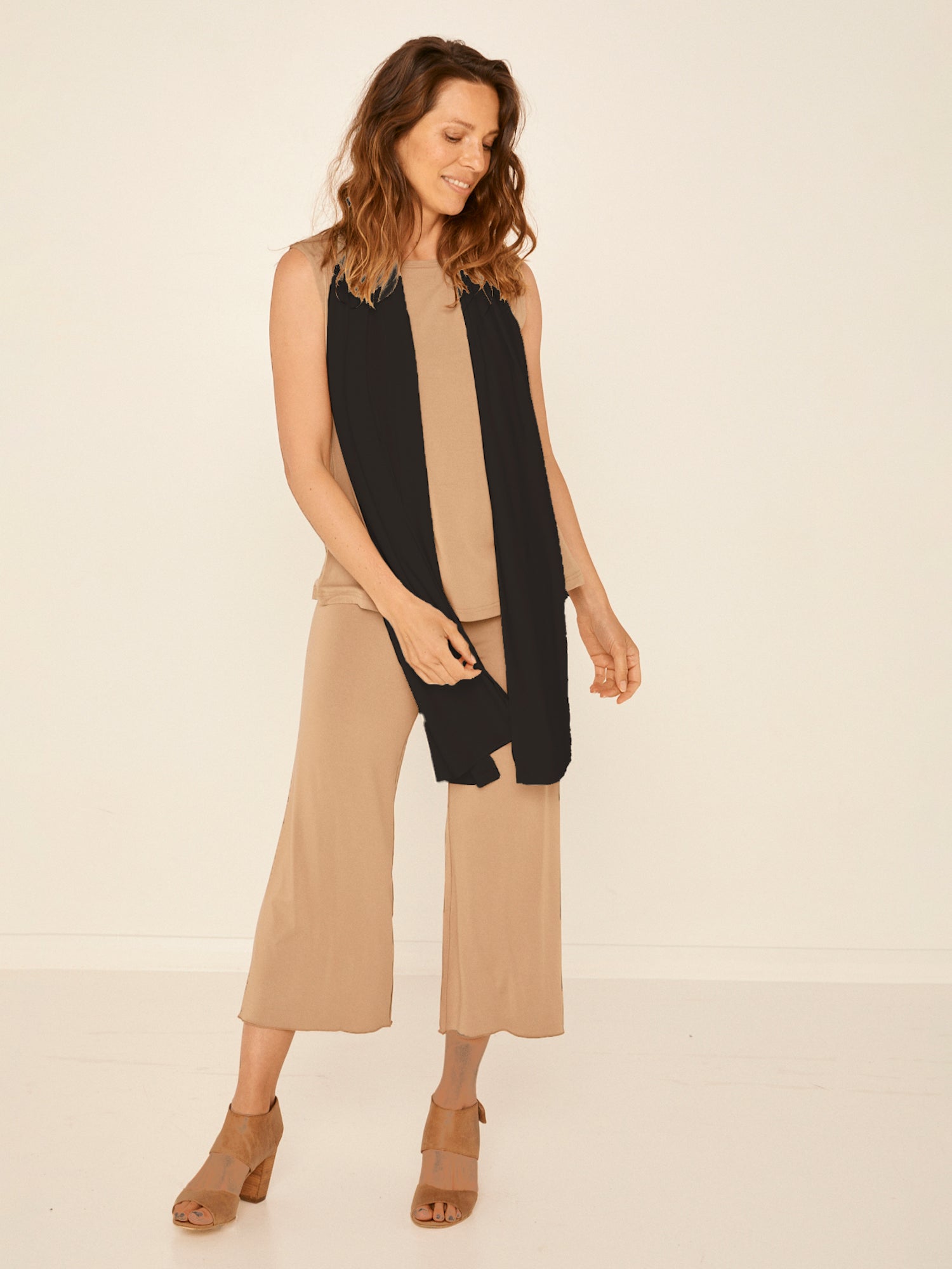 Model wearing black large scarf, convertible style worn as scarf, wrap and shawl, women's bamboo clothing accessories