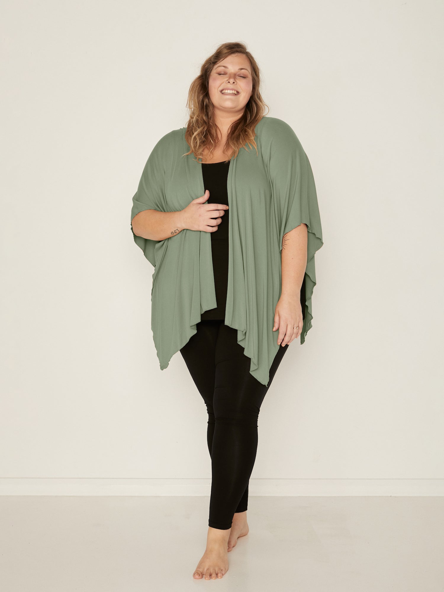 Model wearing eucalyptus green large nourishing wrap, women's bamboo clothing