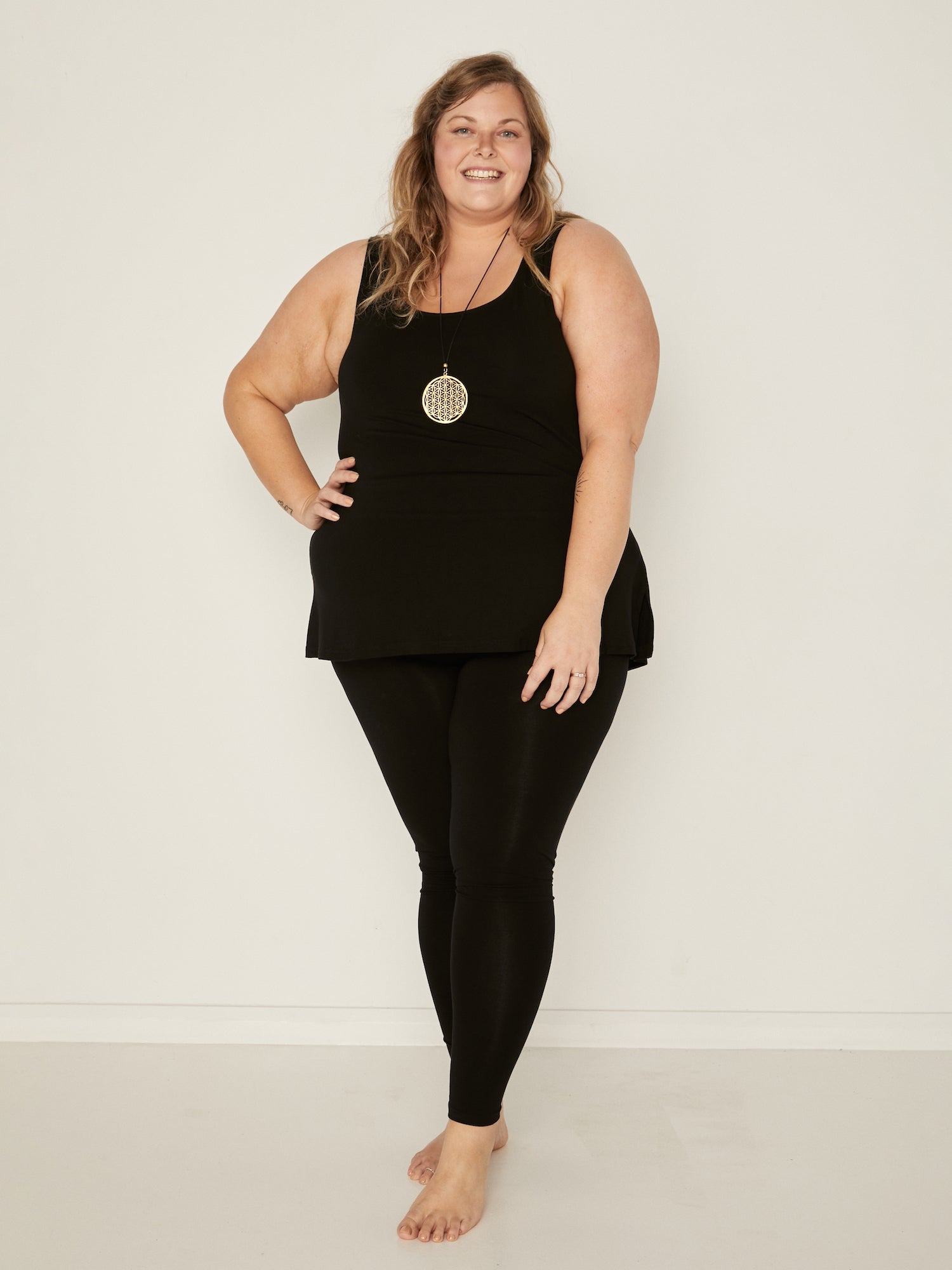 Model wearing black long ankle length tights, double layered high waistband, women's bamboo clothing