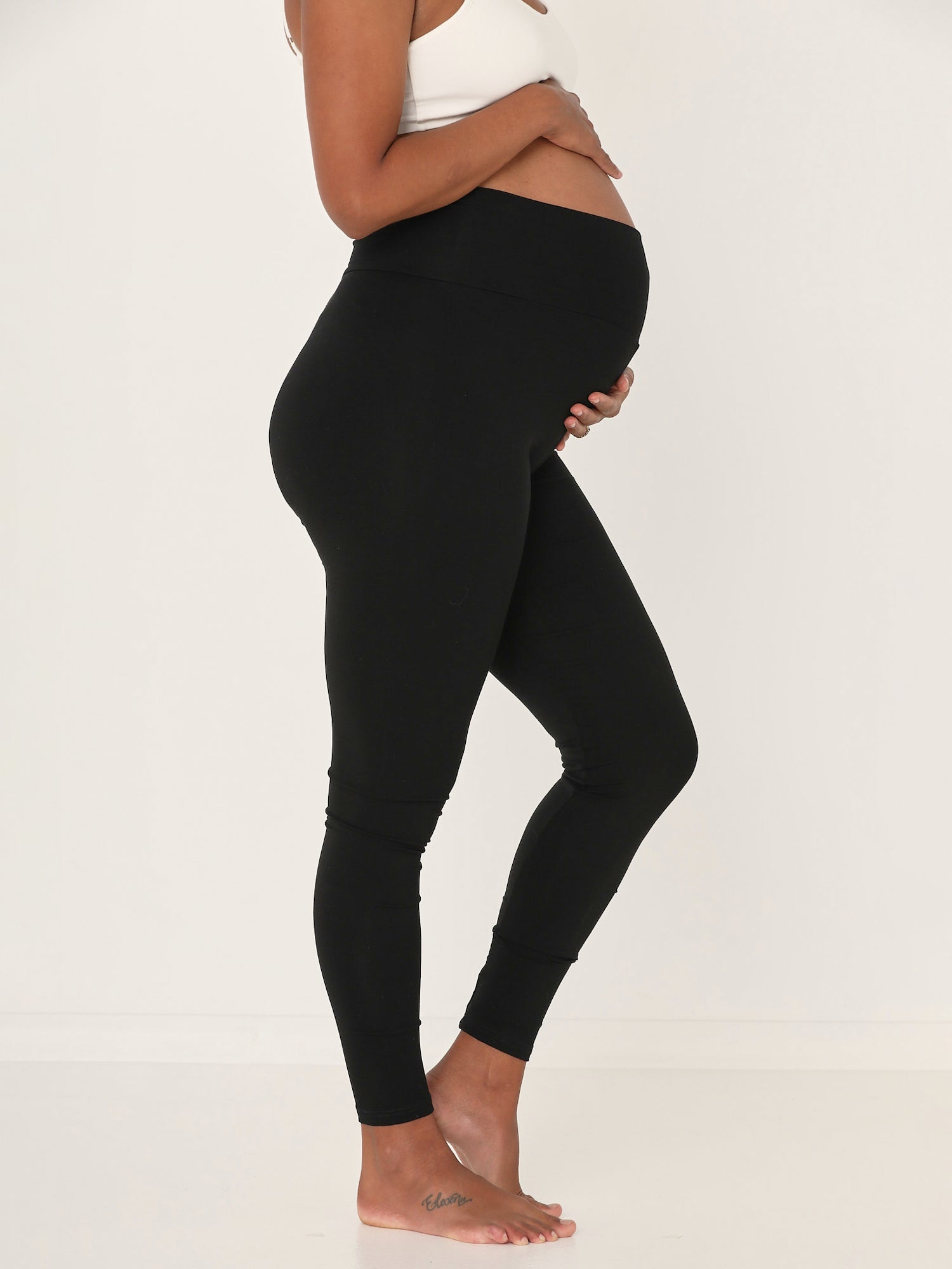 Model wearing black long ankle length tights, double layered high waistband, women's bamboo clothing