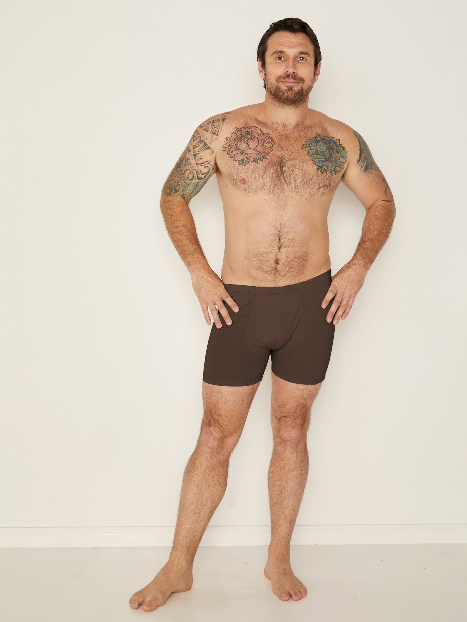 Male model wearing cocoa trunk style boxer shorts with a soft elasticated waistband and pouch detail stiching, men's bamboo underwear