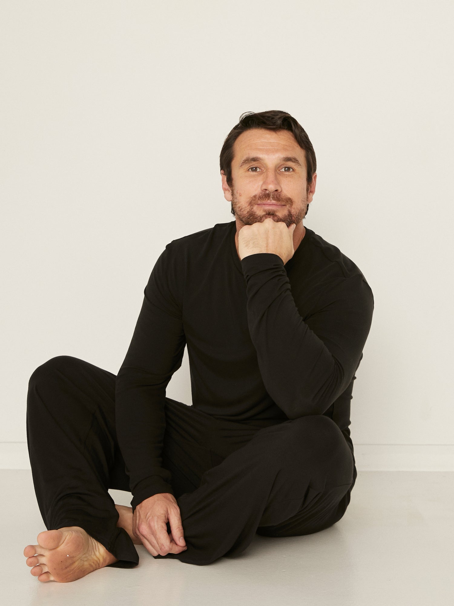 Male model full length black casual pants with elasticised waist, relaxed loose leg and deep pockets, men's bamboo clothing