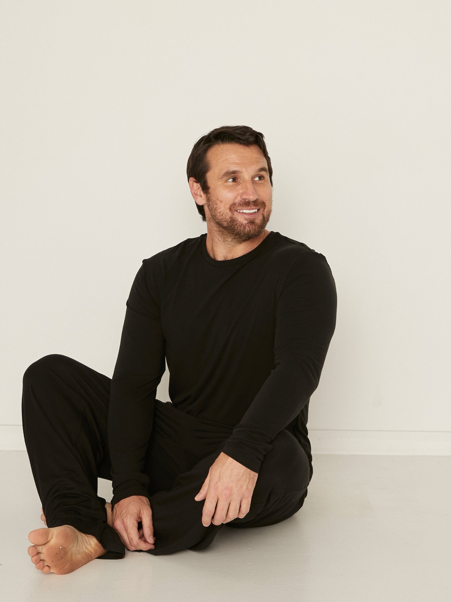 Male model full length black casual pants with elasticised waist, relaxed loose leg and deep pockets, men's bamboo clothing