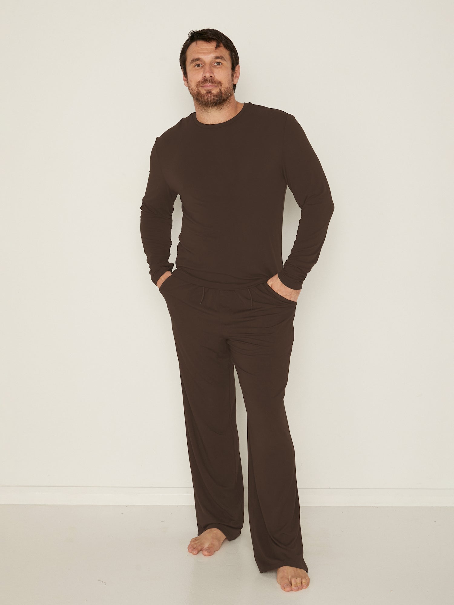 Male model wears Bamboo Casual Pants and Men's Long Sleeve Tee in Cocoa