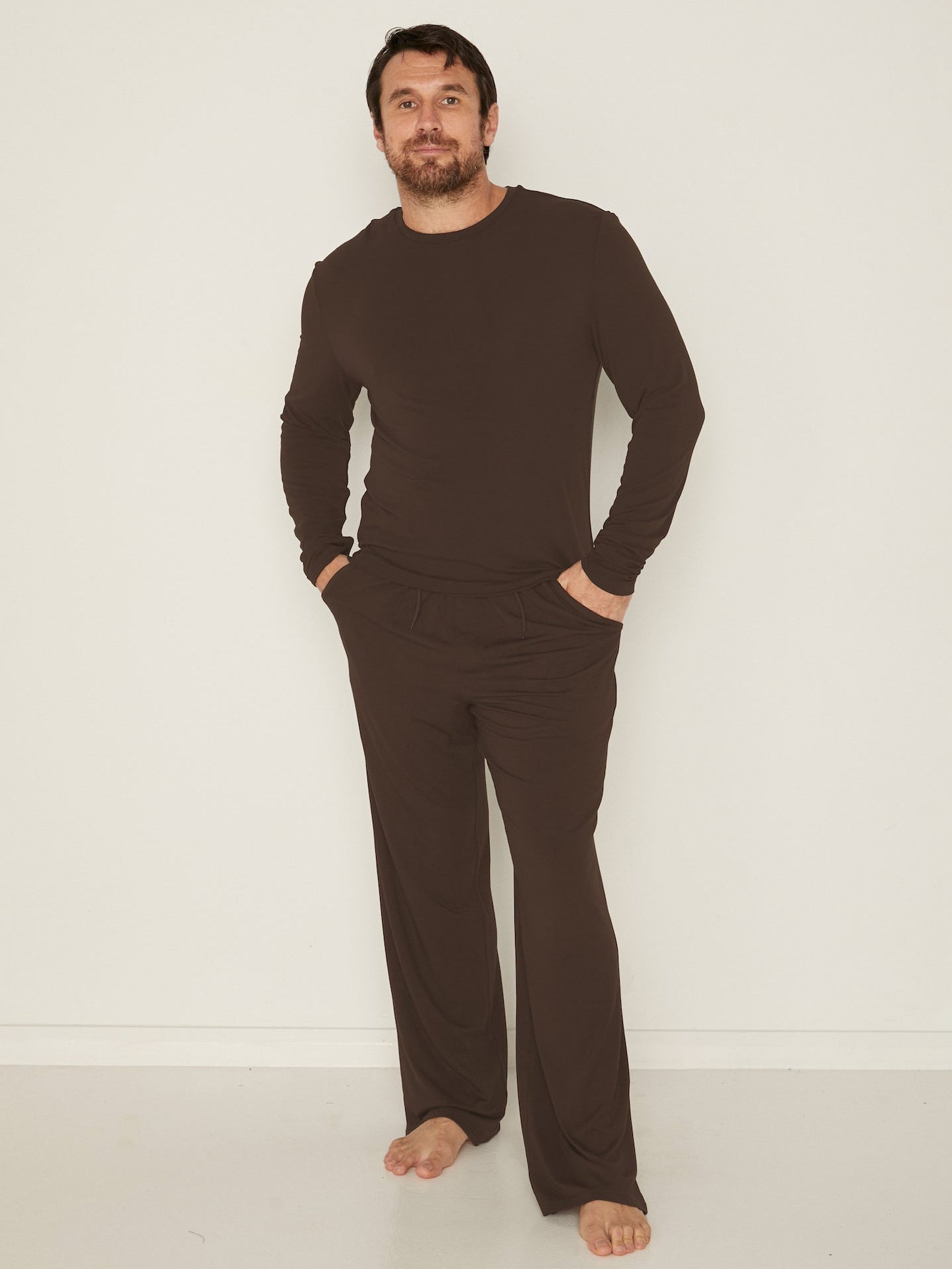 Male model wears Bamboo Casual Pants and Men's Long Sleeve Tee in Cocoa
