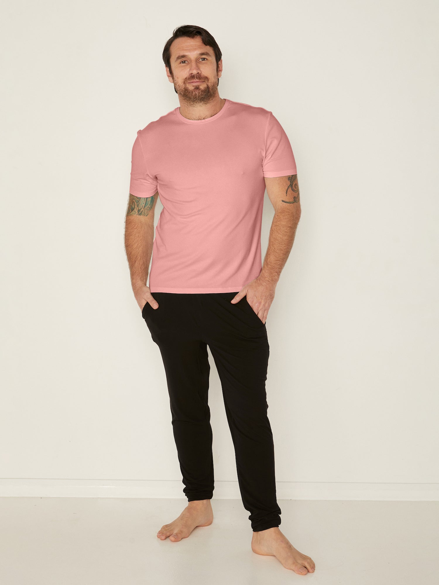 Male model wearing dusty pink generous classic fit tee, soft neckband, crew neckline, short sleeve, men's bamboo clothing