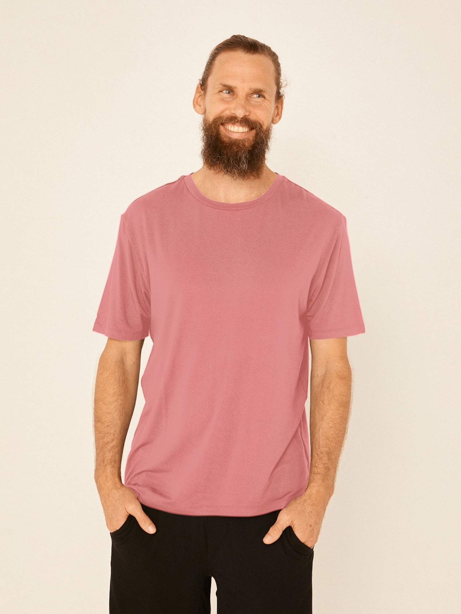 Male model wearing dusty pink generous classic fit tee, soft neckband, crew neckline, short sleeve, men's bamboo clothing