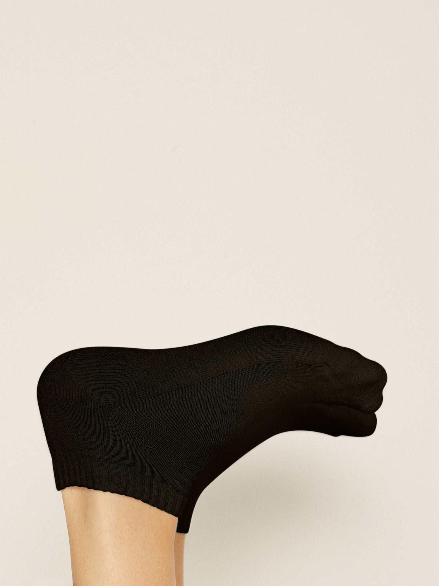 Model wearing black bamboo pedi ankle socks, ribbed top, low rise with cushioned sole, bamboo socks