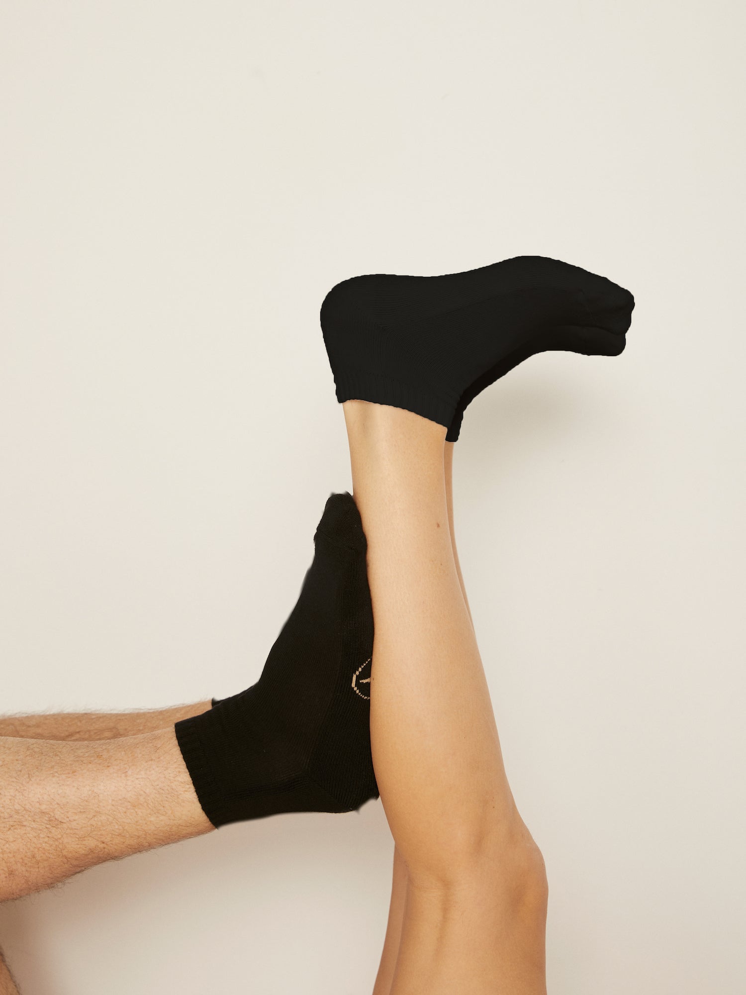 Model wearing black bamboo pedi ankle socks, ribbed top, low rise with cushioned sole, bamboo socks