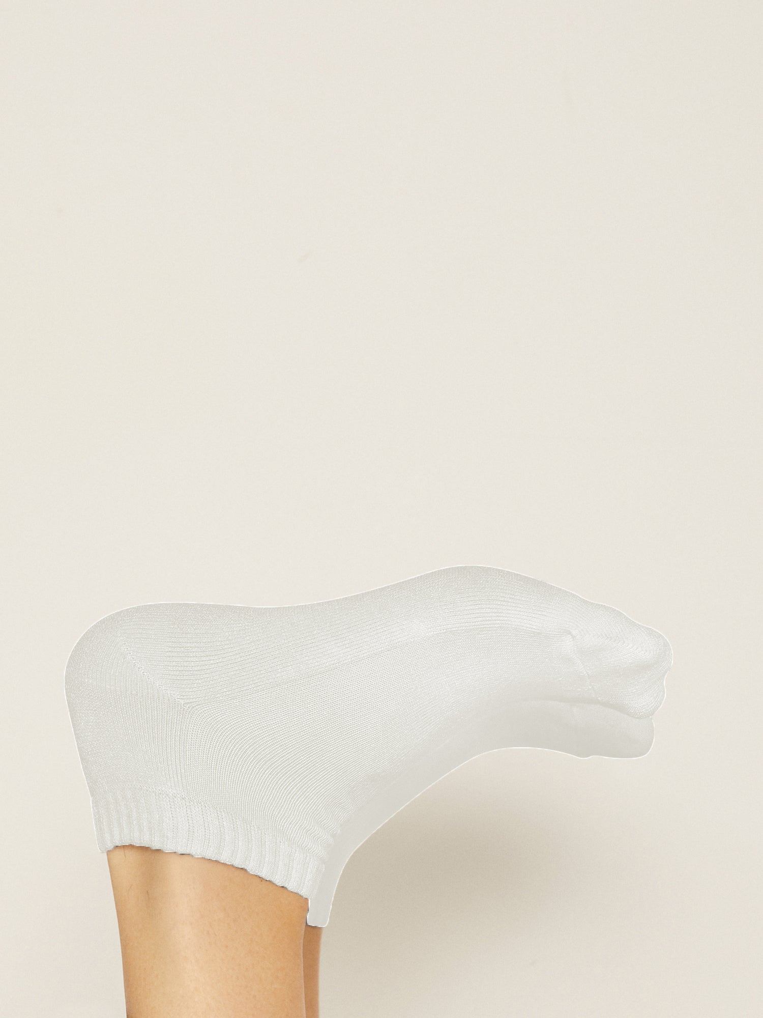 Model wearing white bamboo pedi ankle socks, ribbed top, low rise with cushioned sole, bamboo socks