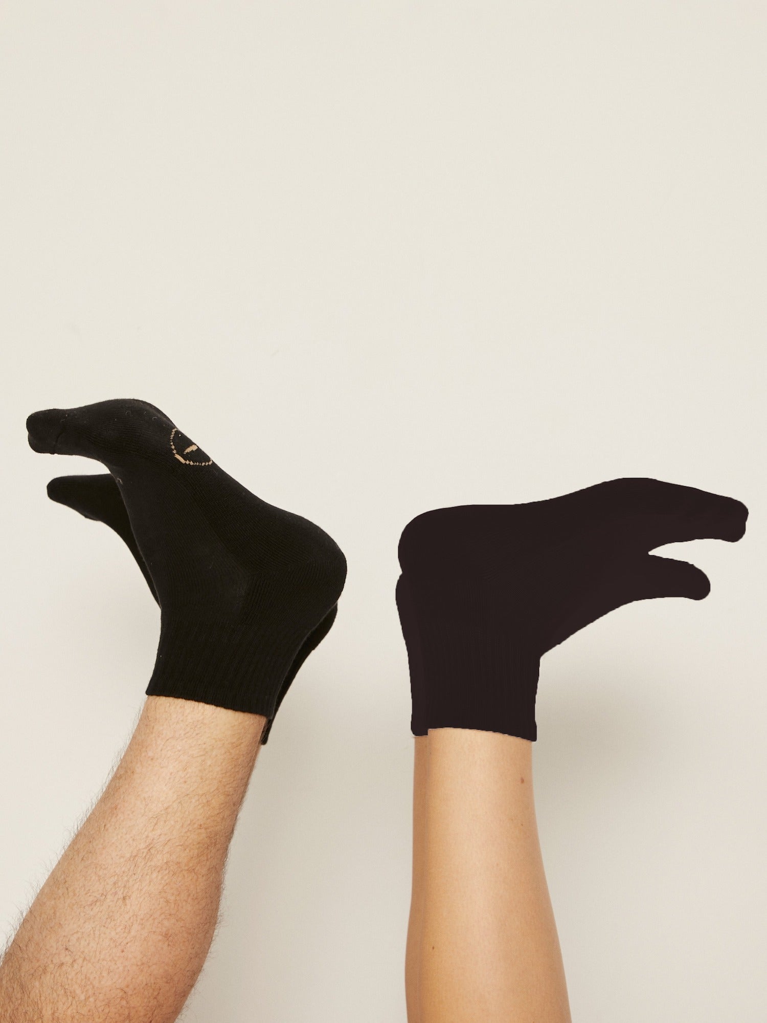Model wearing black bamboo crew socks, mid to low rise, ribbed ankle support and cushioned sole, bamboo sport sock