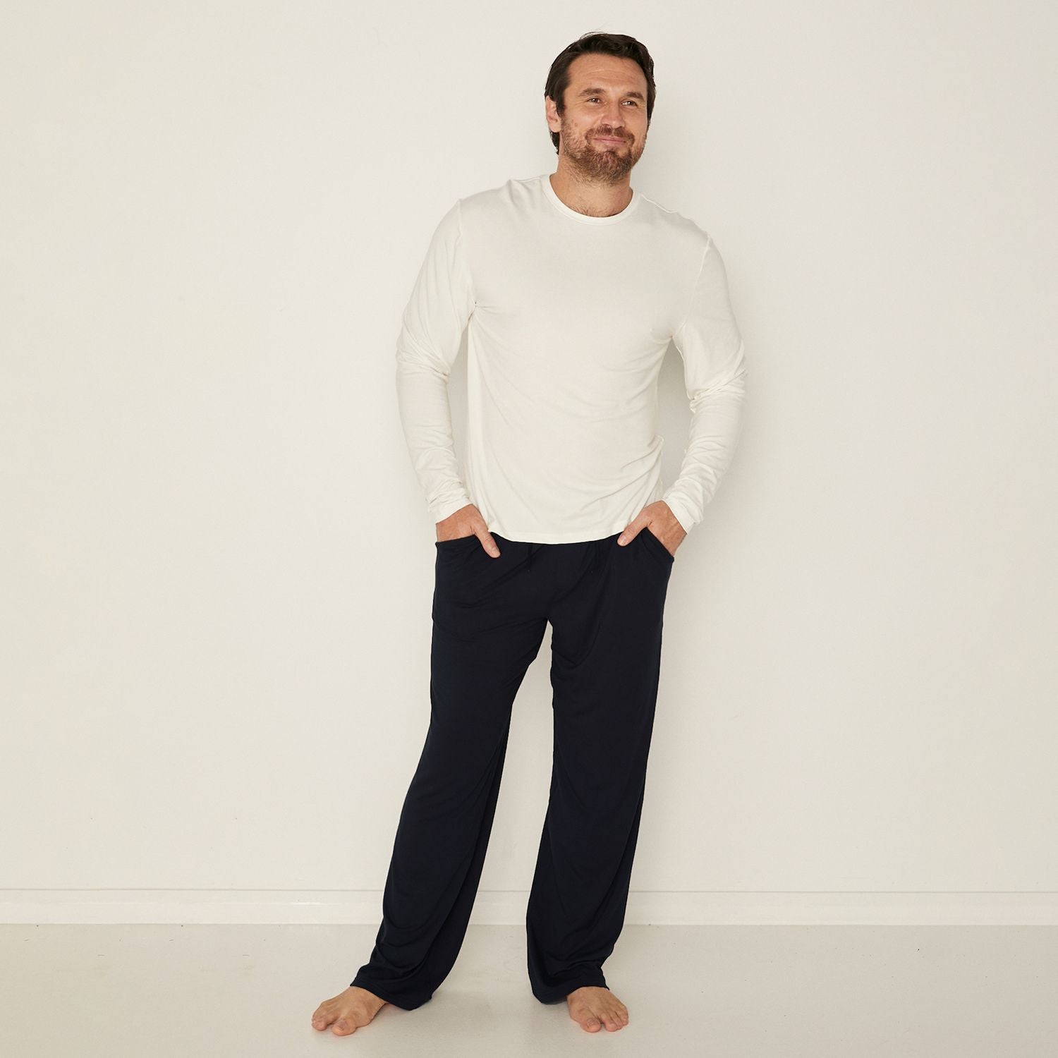 male model wearing men's bamboo black casual pants and white long sleeve tee