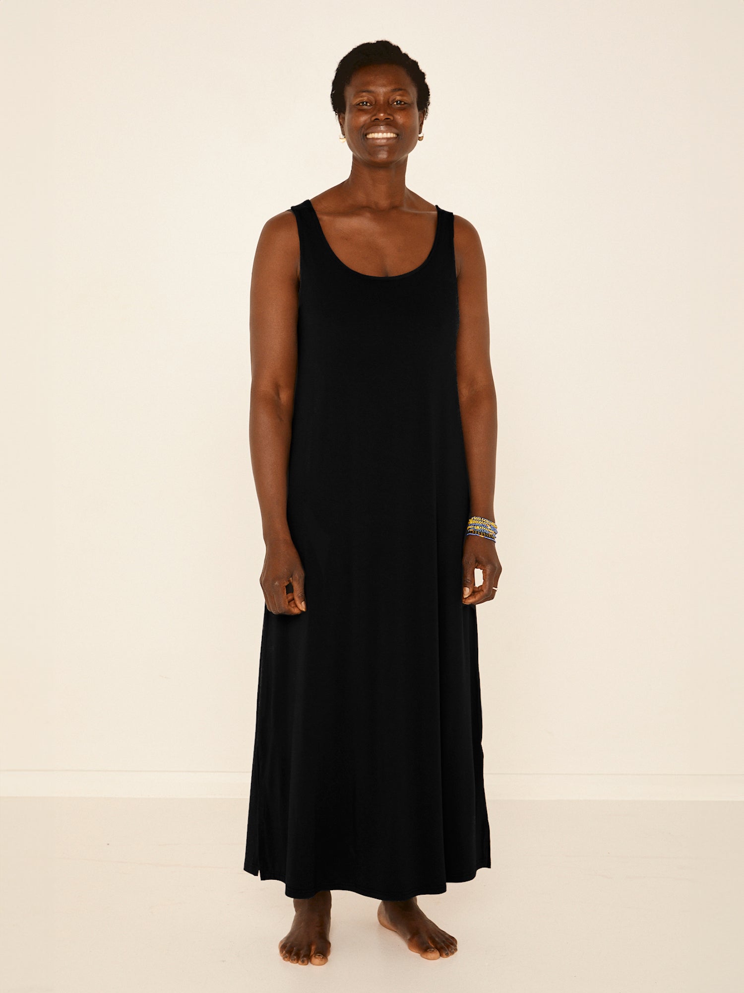 Model wearing a reversible black maxi length dress with scoop and boat necklines, women's bamboo clothing