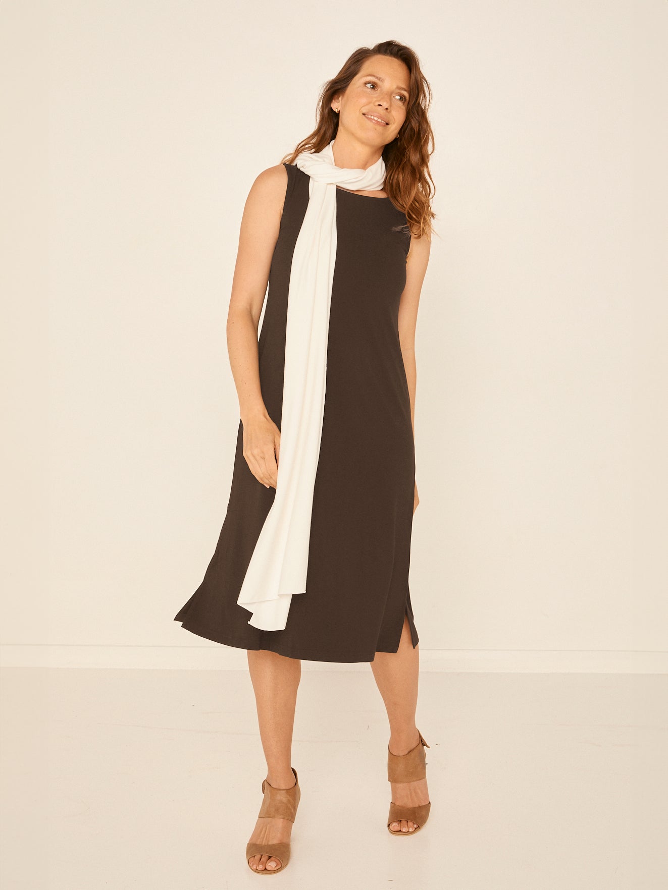 Model wearing a reversible cocoa brown midi length a-line dress with scoop and boat necklines, women's bamboo clothing
