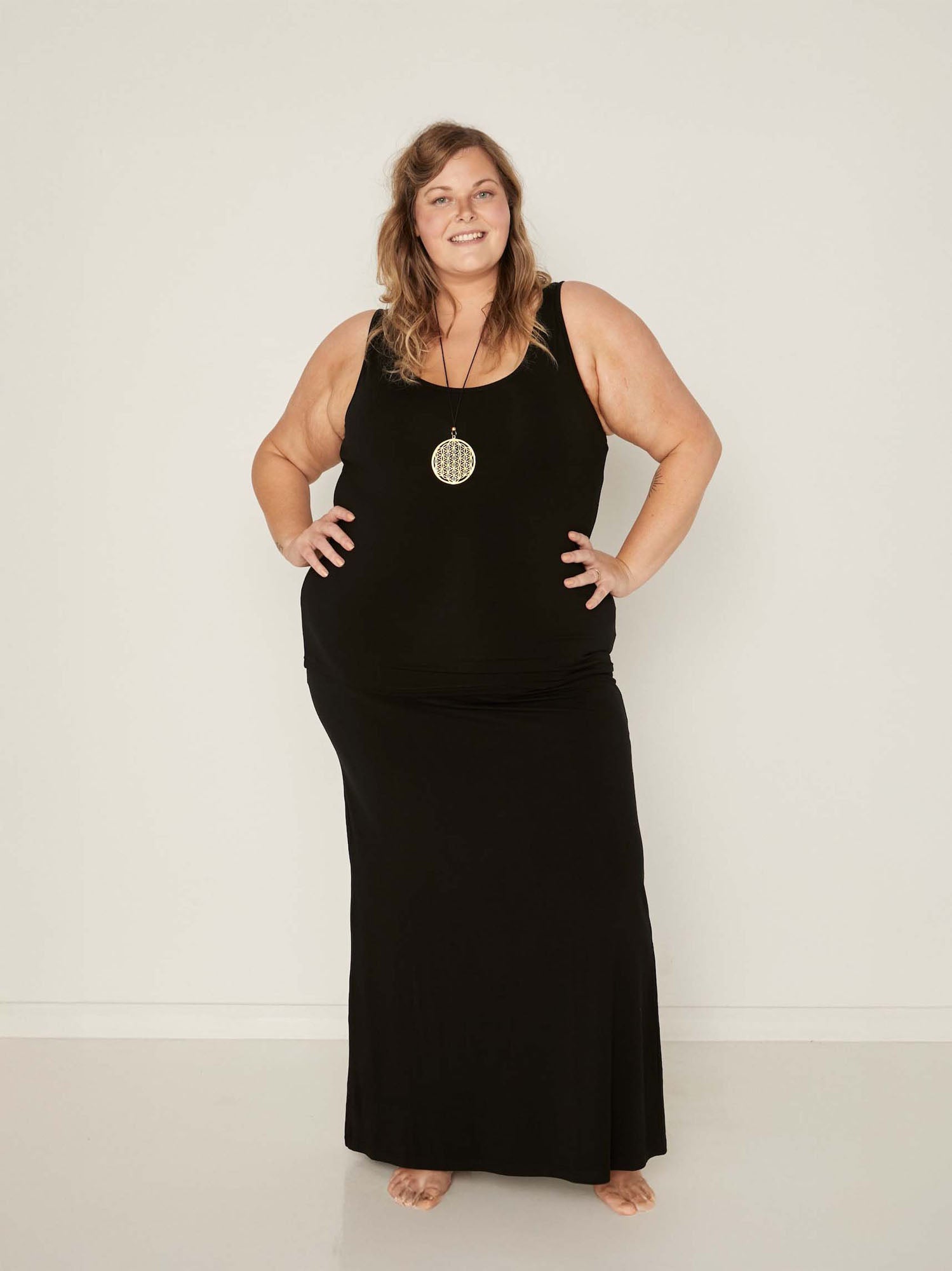 model wearing a long black maxi length skirt with classic singlet, women's bamboo clothing