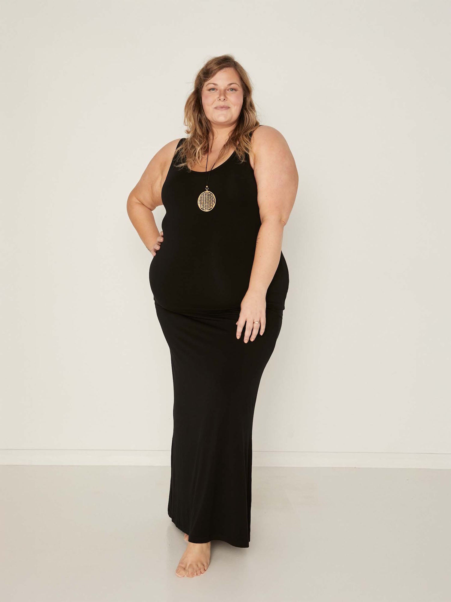 model wearing a long black maxi length skirt with classic singlet, women's bamboo clothing