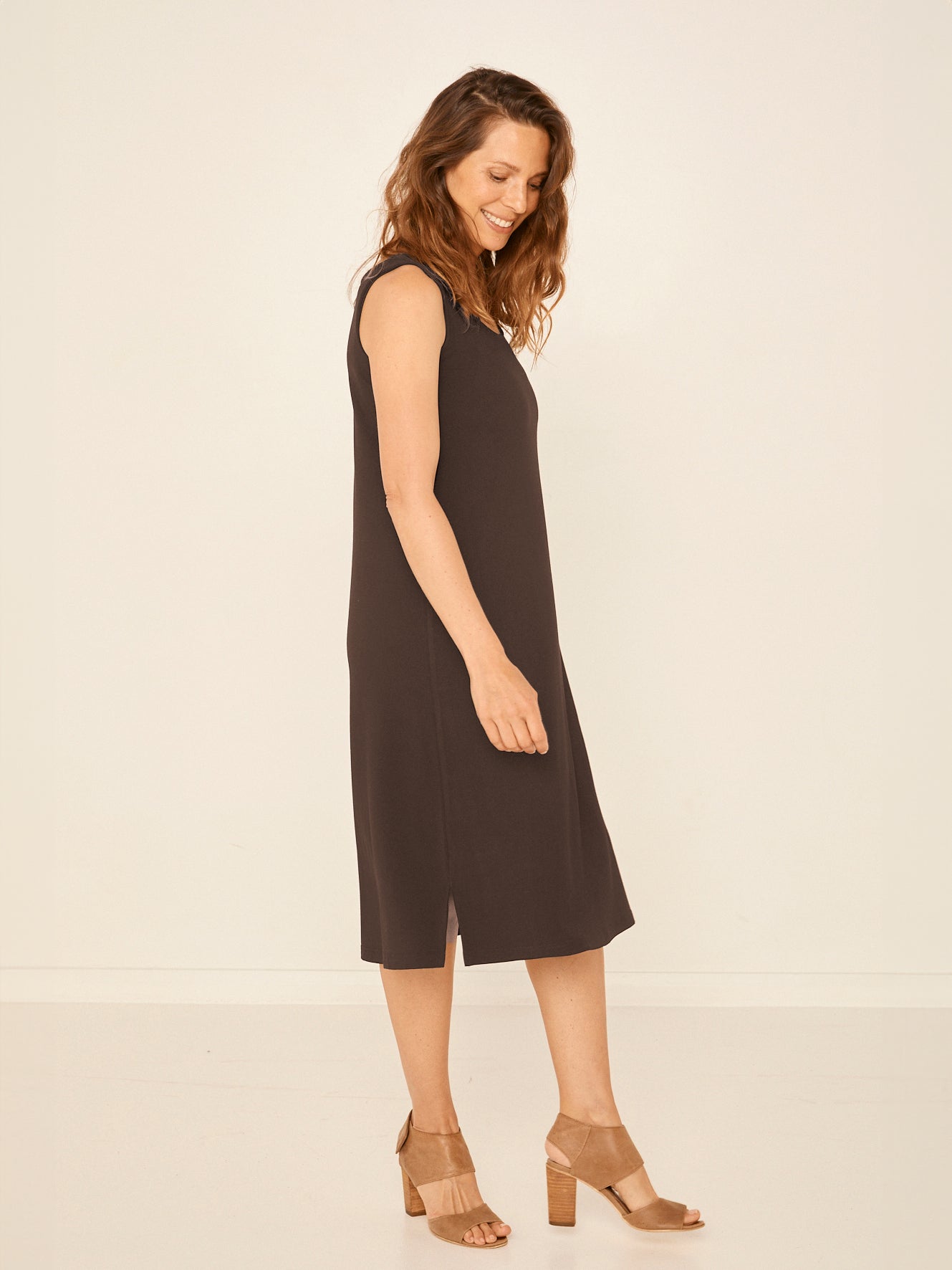 Model wearing a reversible cocoa brown midi length a-line dress with scoop and boat necklines, women's bamboo clothing