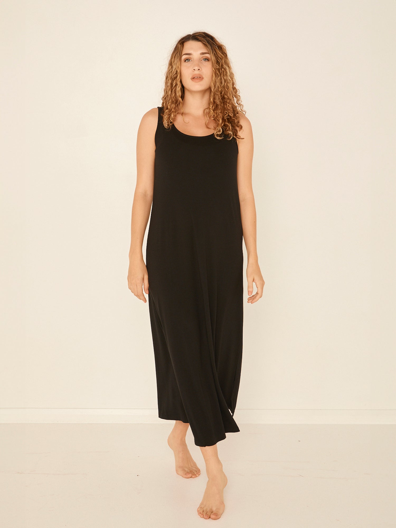 Model wearing a reversible black maxi length dress with scoop and boat necklines, women's bamboo clothing
