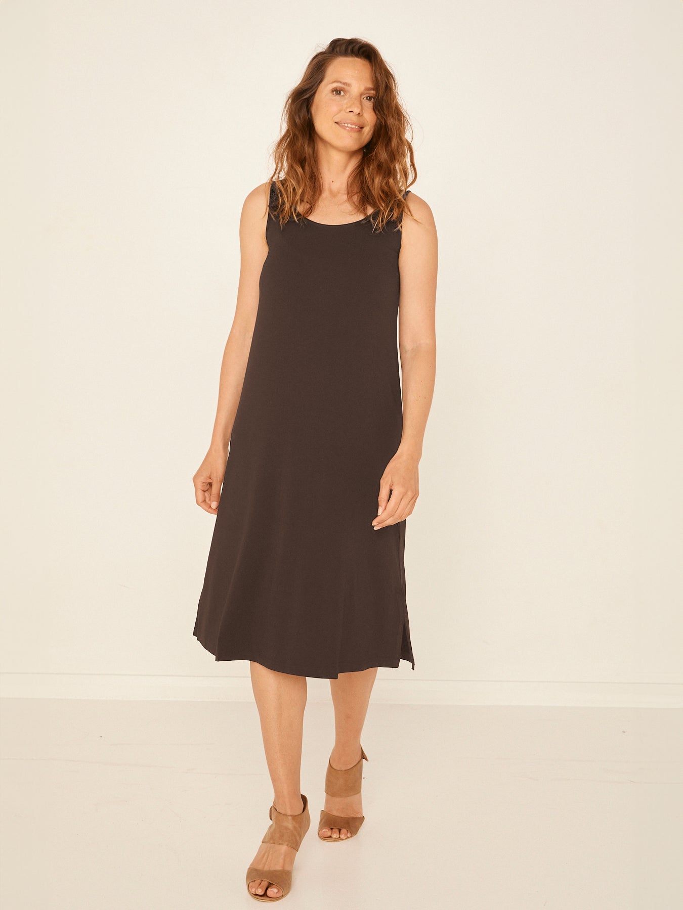 Model wearing a reversible cocoa brown midi length a-line dress with scoop and boat necklines, women's bamboo clothing